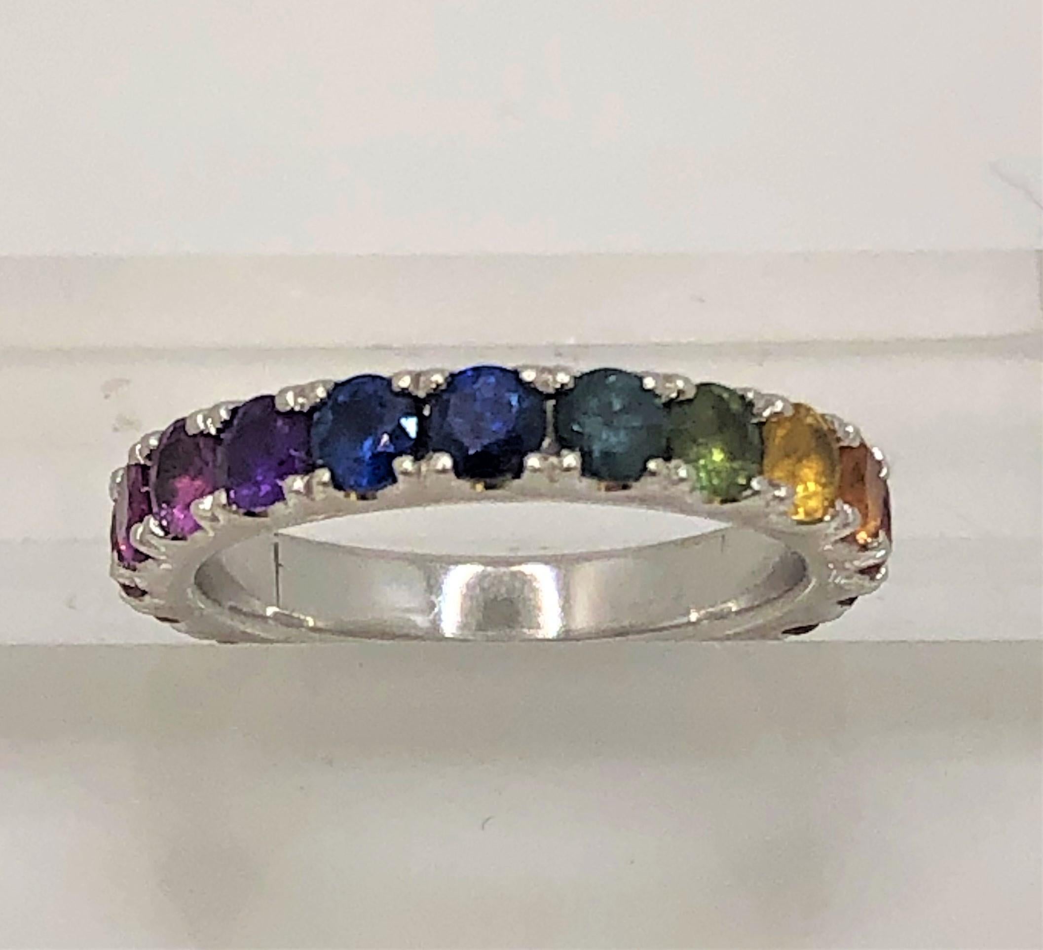 This is an everyday ring as it will match any color!  Great for stacking , too!
20 round multi-colored sapphires, prong set.
Vibrant red, orange, yellow, green, blue, purple, pink colors.
Approximately 2.25 total carat weight.
18 karat white