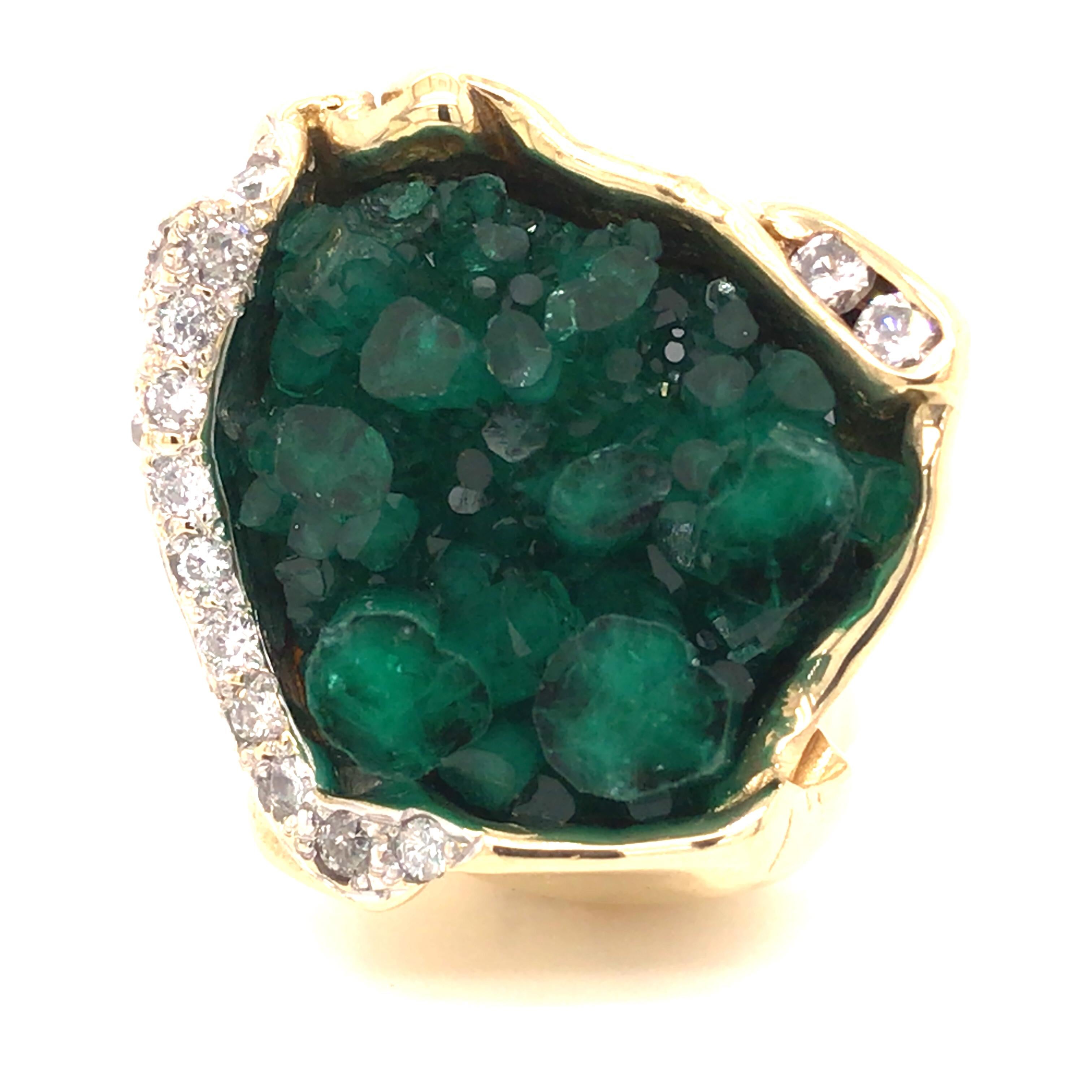 18K Raised Rough Emerald Diamond Ring Yellow Gold.  Rough Emerald is expertly set accented with Round Brilliant Cut Diamonds weighing 0.52 carat total weight, G-I in color and SI in clarity.  The Ring measures 1 inch in length and width. Ring size