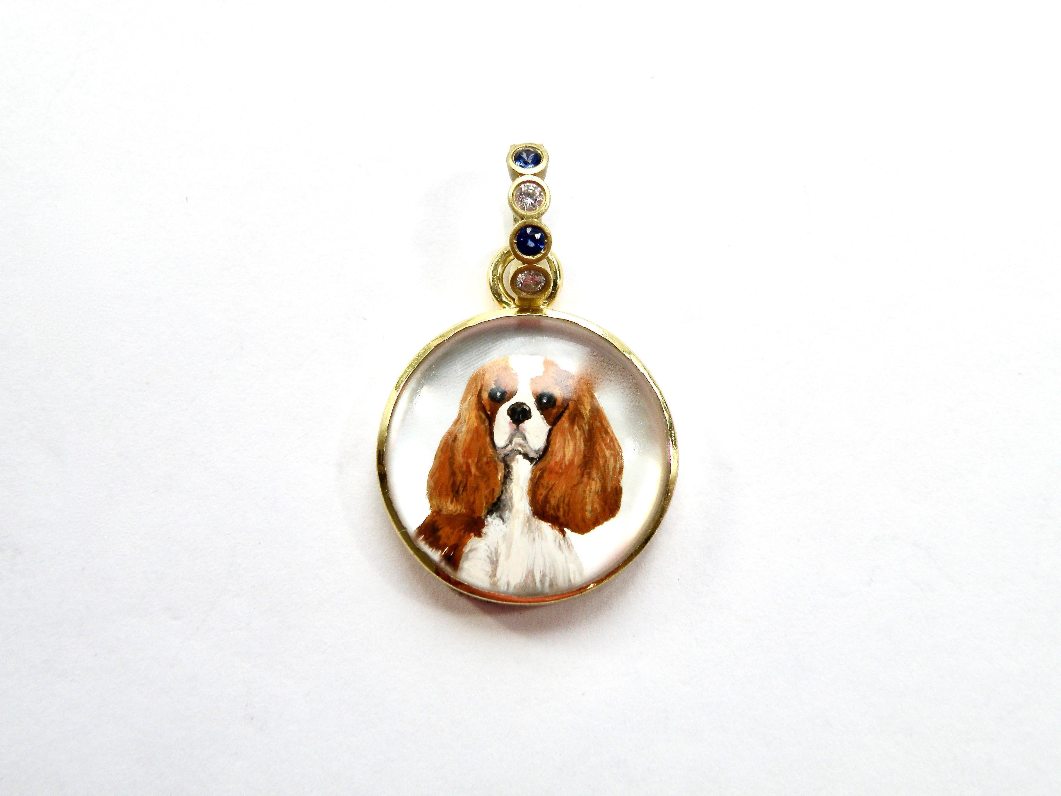 18K king charles calvalier pendant hand painted on crystal with mother of pearl backing and sapphire bail