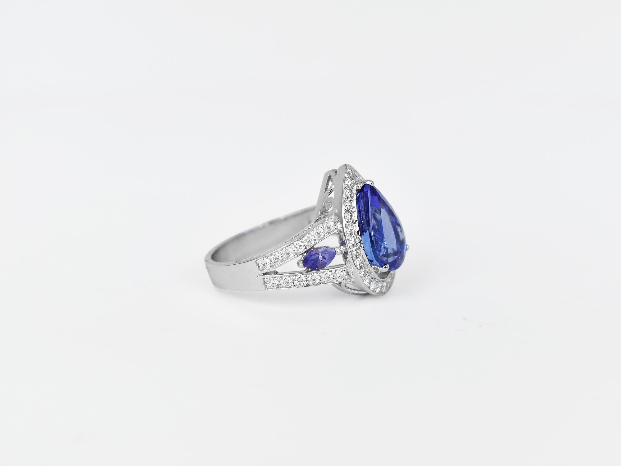 18k Ring White Gold Ring Diamond Ring  Tanzanite Ring Blue Tanzanite Pear Shape Ring  
     This 18K solid white Gold Tanzanite / Diamond bezel halo ring. The fine Quality gold finishing with pear shape Tanzanite & scintillating cluster pave set