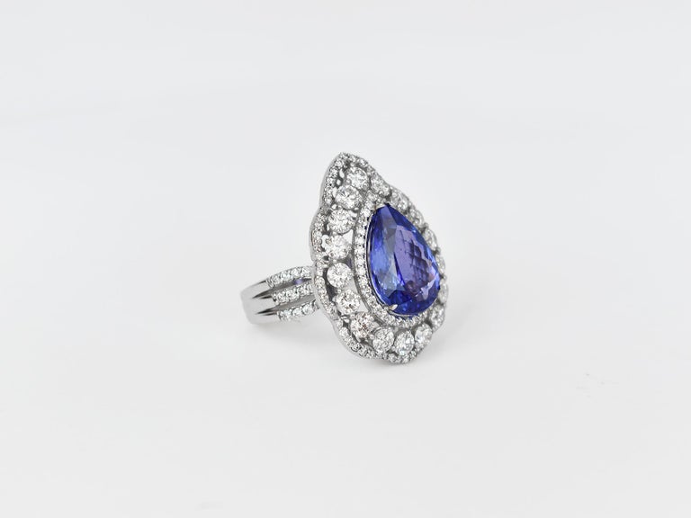 18k Ring White Gold Ring Diamond Ring  Tanzanite Pear Shap Ring  
           This 18K solid white Gold Tanzanite / Diamond estate ring. The fine Quality gold finishing with pear shape Tanzanite & scintillating cluster pave set diamonds.  
        