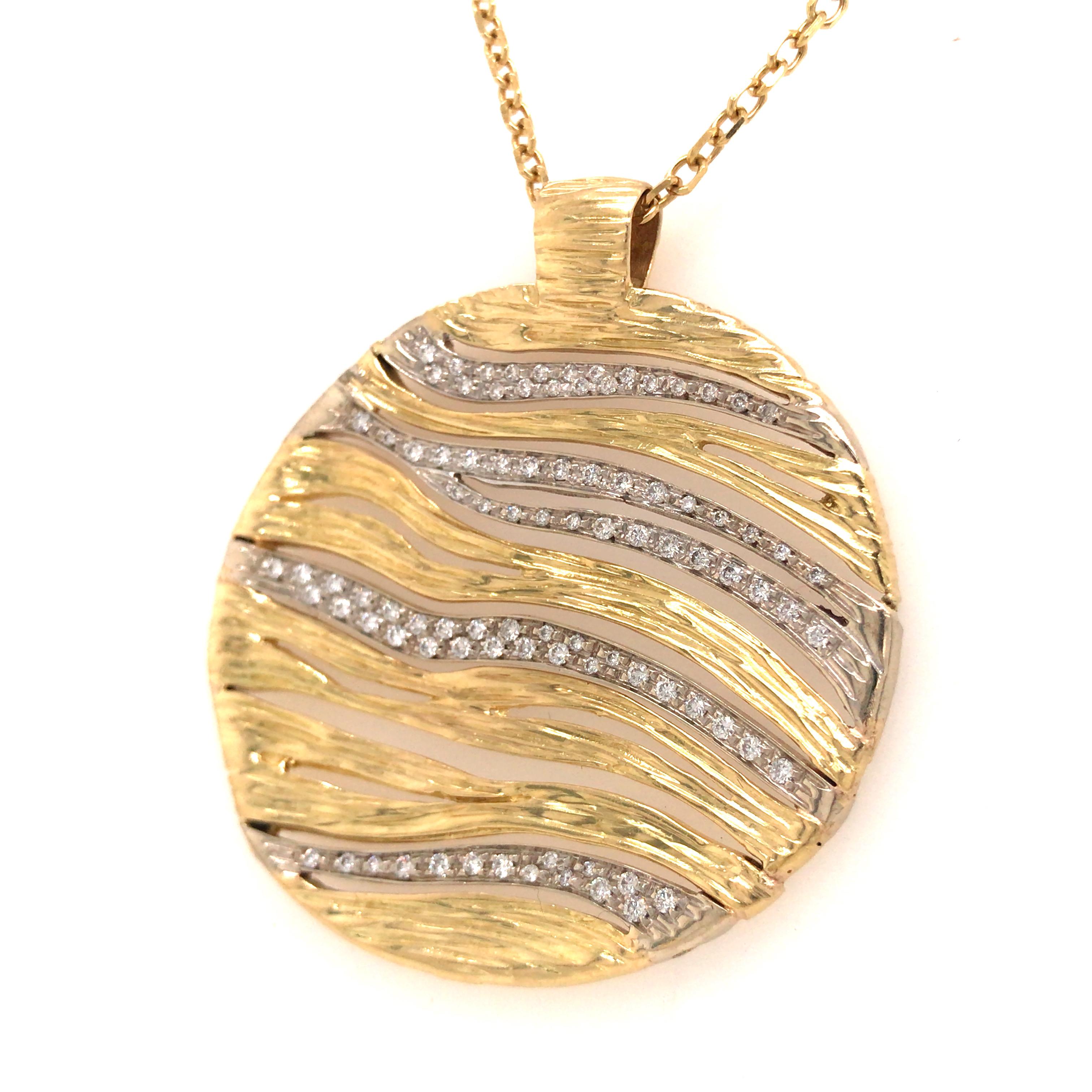 Roberto Coin Diamond and Gold Medallion Pendant in 18K Yellow Gold.  (92) Round Brilliant Cut Diamonds weighing 0.80 carat total weight, G-H in color and VS in clarity are expertly set in a wave pattern with textured Gold.  The Pendant measures 1