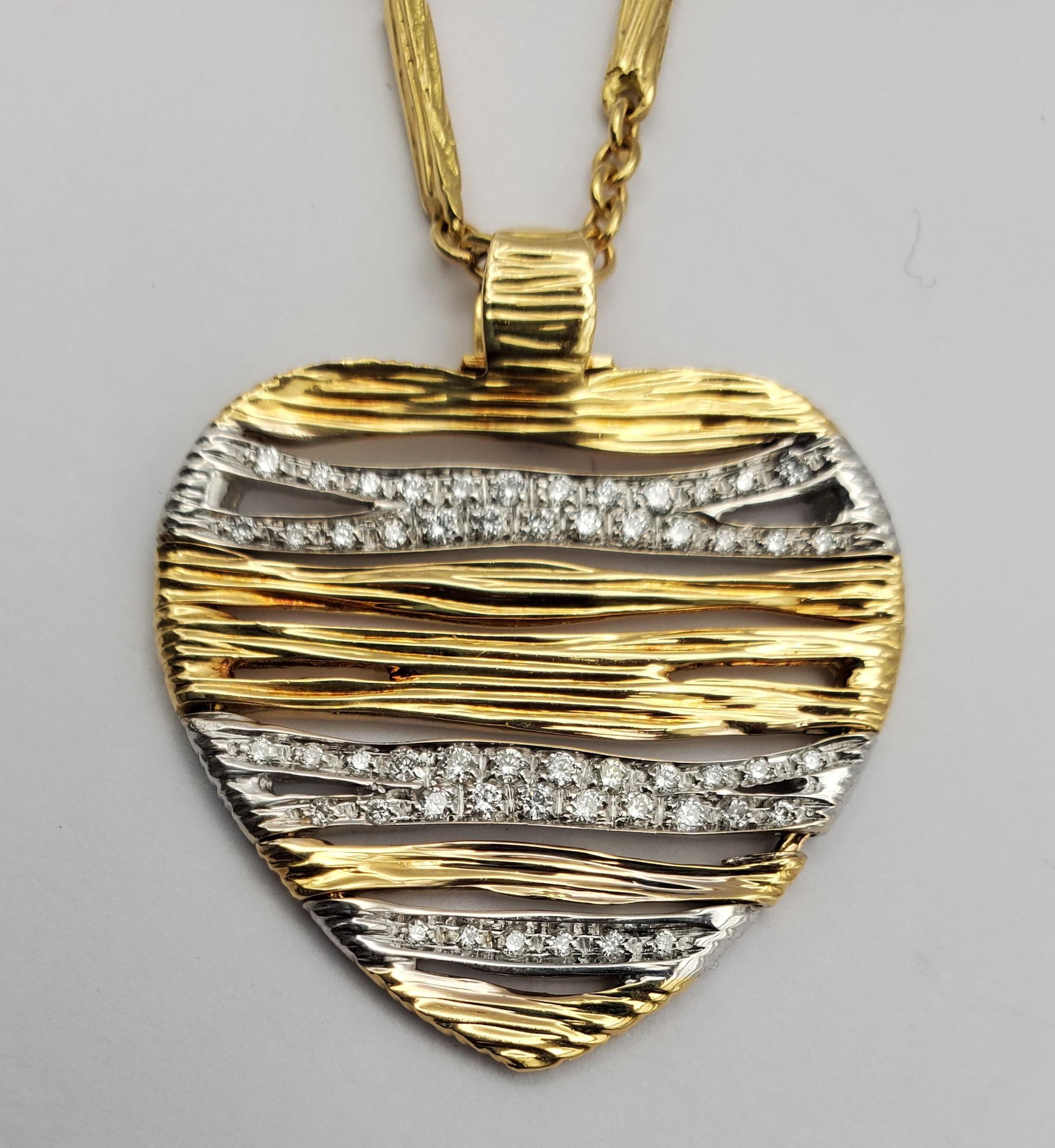 Roberto Coin Diamond Heart Pendant from Elephant (Elefantino) Collection
consisting of an 18k yellow and white gold heart pendant which is a textured, articulated pendant, set throughout with round brilliant cut diamonds. The diamonds have a
