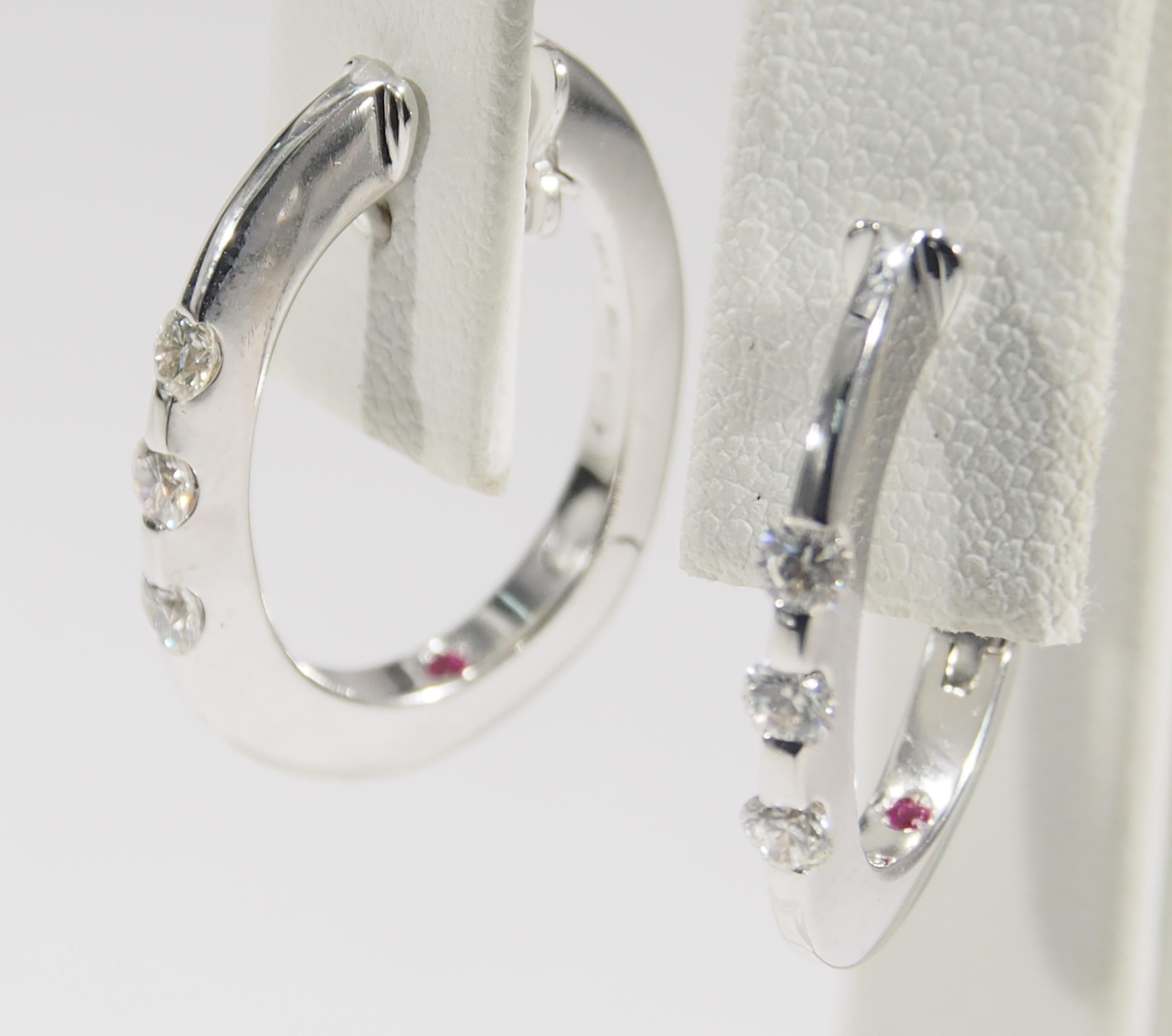 From the well known jewelry designer, Roberto Coin are these 18K White Gold Oval Hoop Earrings. The Earrings are accented with (6) Round Brilliant Cut Diamonds, G-H in Color, VS in Clarity channel set to sparkle in a row and weigh approximately