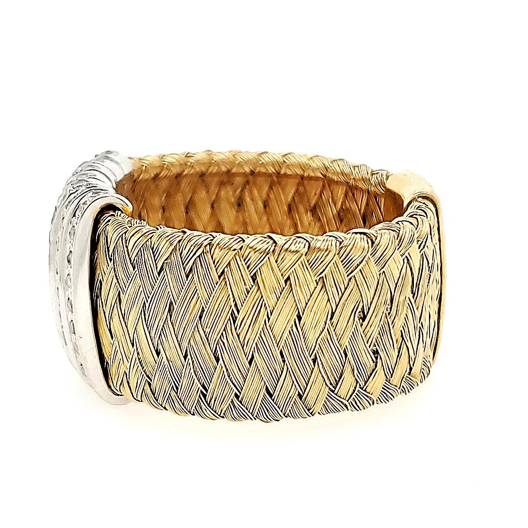 Roberto Coin Silk Weave ring in 18k Yellow Gold with center diamond station. (77) Round Brilliant Cut Diamonds .77 carat total weight, G-H in color, VS in clarity are set in (7) 14k White Gold Bands in a center station. The Ring is 1/2 inch wide,