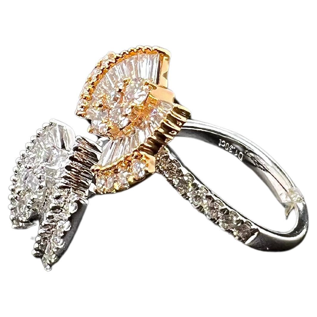 This beautiful, modern approach to a butterfly ring will catch everyone's attention! This beautiful ring is made in rose gold and white gold with baguette diamonds set as the wings. The round brilliant diamonds finish out the ring beautifully! This