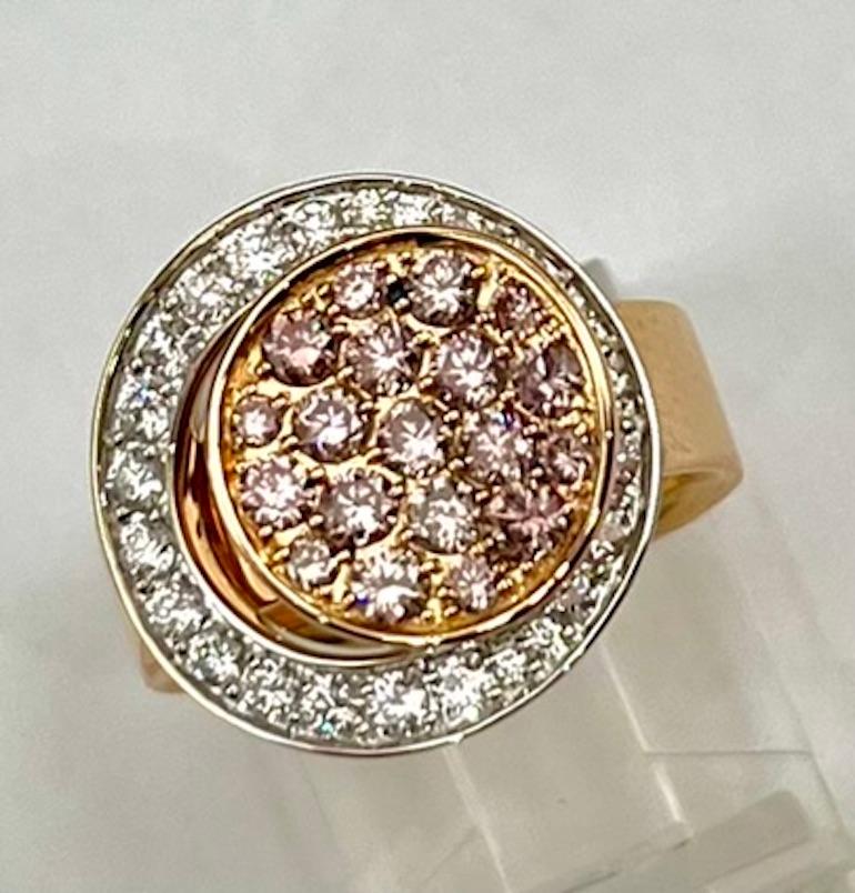 This is modern and elegant ring set with 19 Round Natural Pink Diamonds of .75Ct Total Weight and 24 Round Natural White Diamonds of .57Ct Total Weight. The Two Circle Design is unique and distinguishes the Pink Diamonds. The color of the Pink