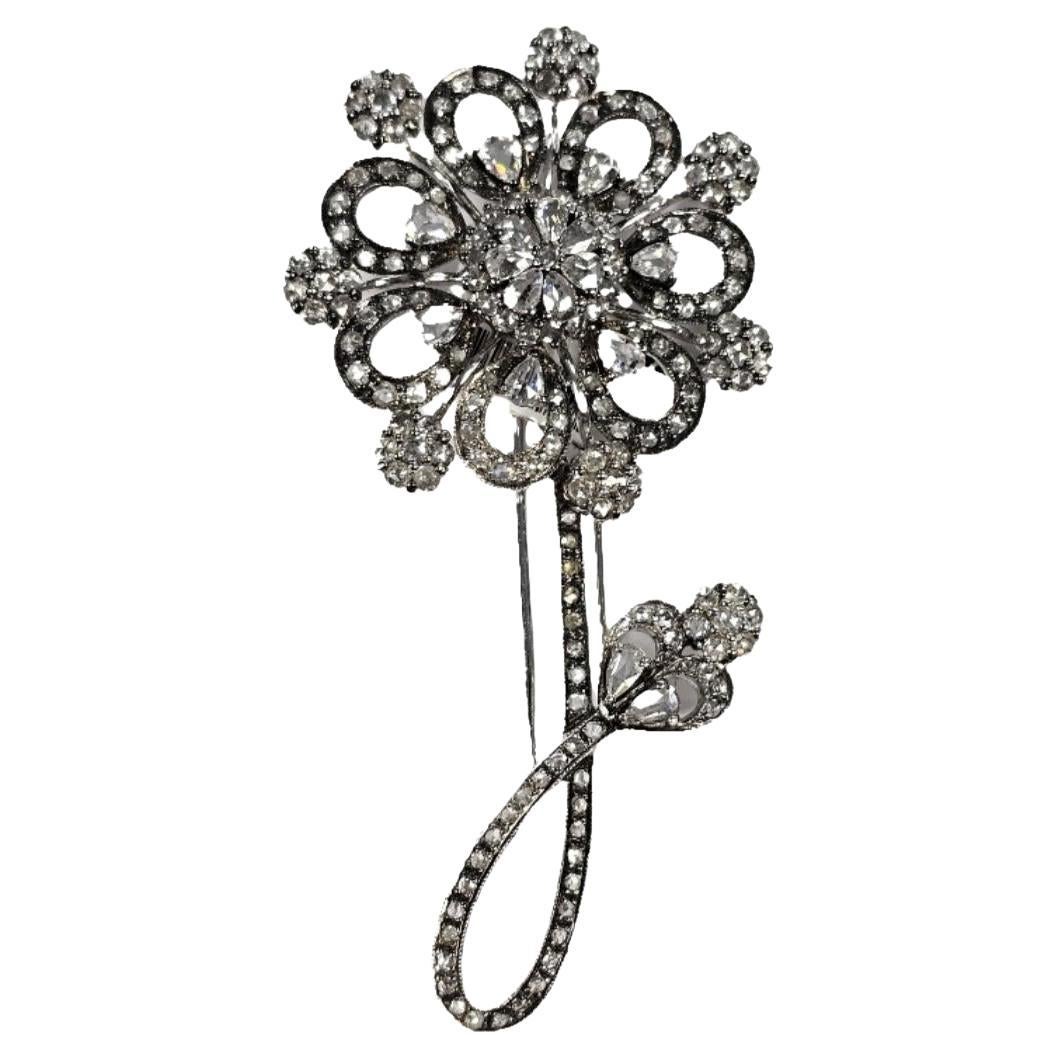 Embellish your outfit with this exquisite 18K Rose Cut Diamond Flower Brooch. Crafted in 18k white gold, it features stunning 4.42 carats of rose cut diamonds, adding a touch of luxury to any look. With its 3.25 in x 1.65 in measurements, it is the
