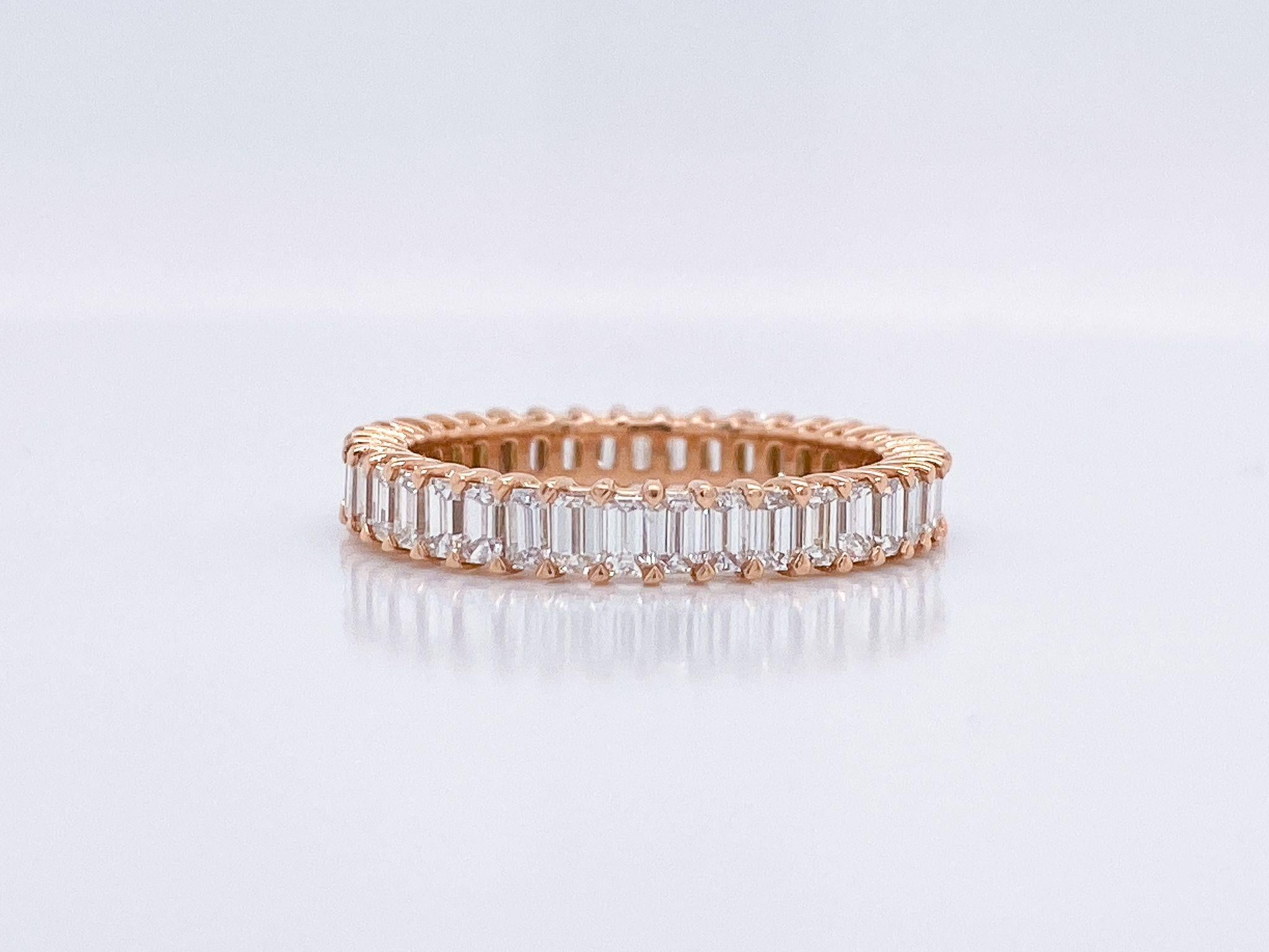 Imagine the look on her face when she sees this Emerald Cut Diamond Eternity Band; featuring 39 Emerald Cut Diamonds, weighing 1.95 Total Carat Weight. These diamonds are H Color, VS Clarity, and are set in a 18K Rose Gold setting in a finger size