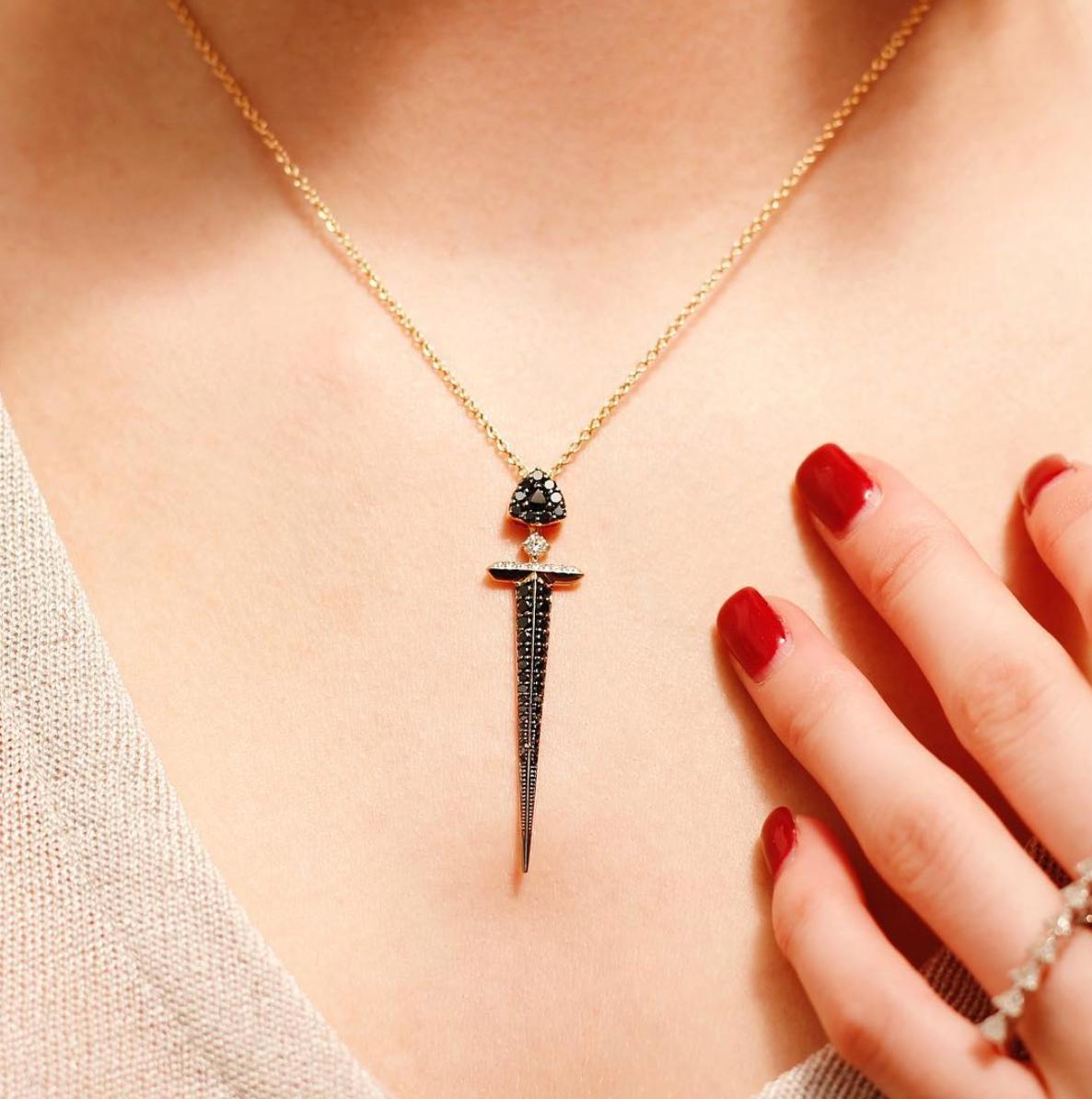 The Sword pendant celebrates the beauty, force and power of womanhood. Flawlessly crafted from 18k rose gold, the unique adjustable necklace combines a mix of black and colourless diamonds with a luxurious modern feeling. With fluidity of movement