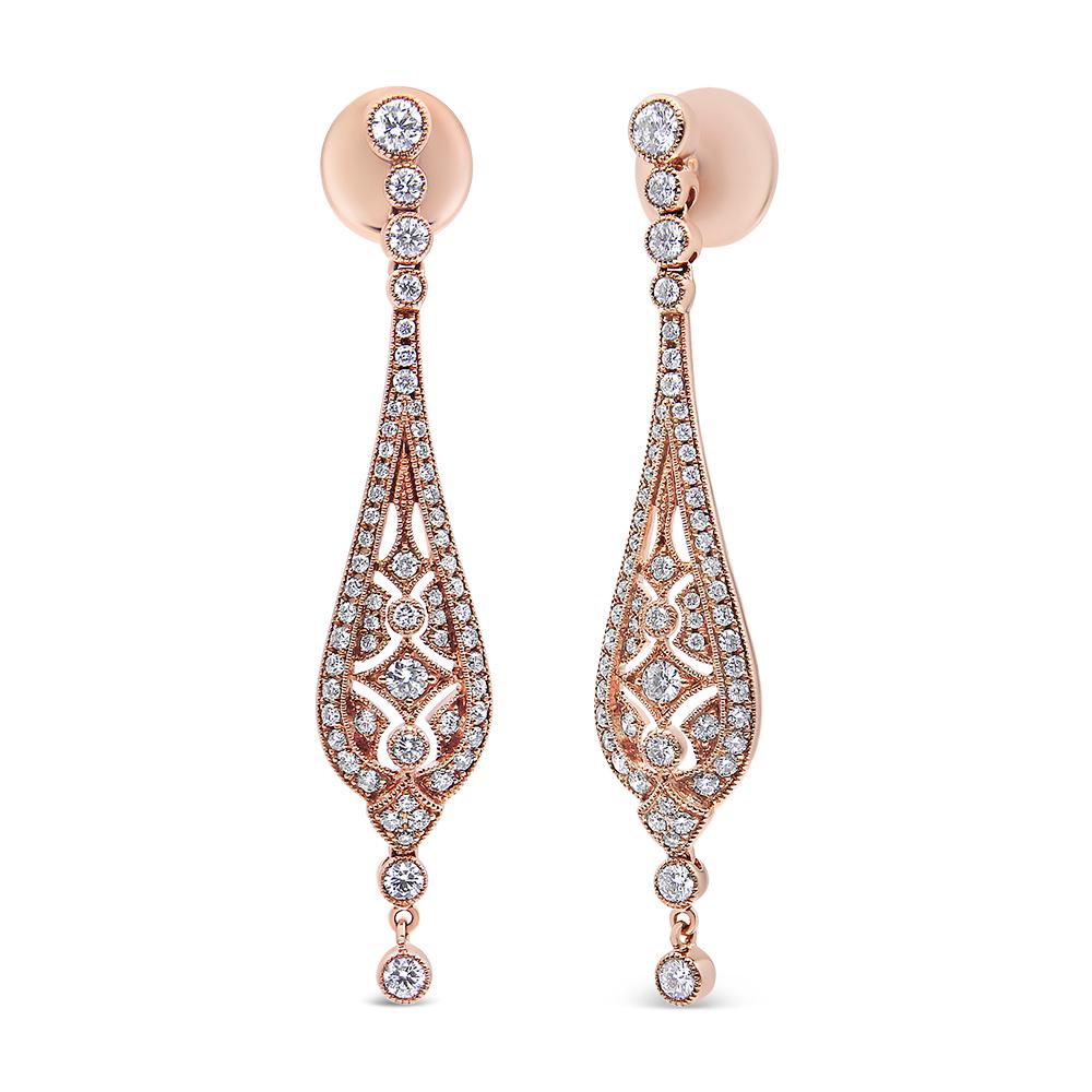 Go back in time with this glamorous pair of Art Deco style drop earrings inspired by the 1920s. These earrings are fashioned from vibrant 18kt rose gold and have an elegant, slender vintage look to them. The earrings start with diamond studded push