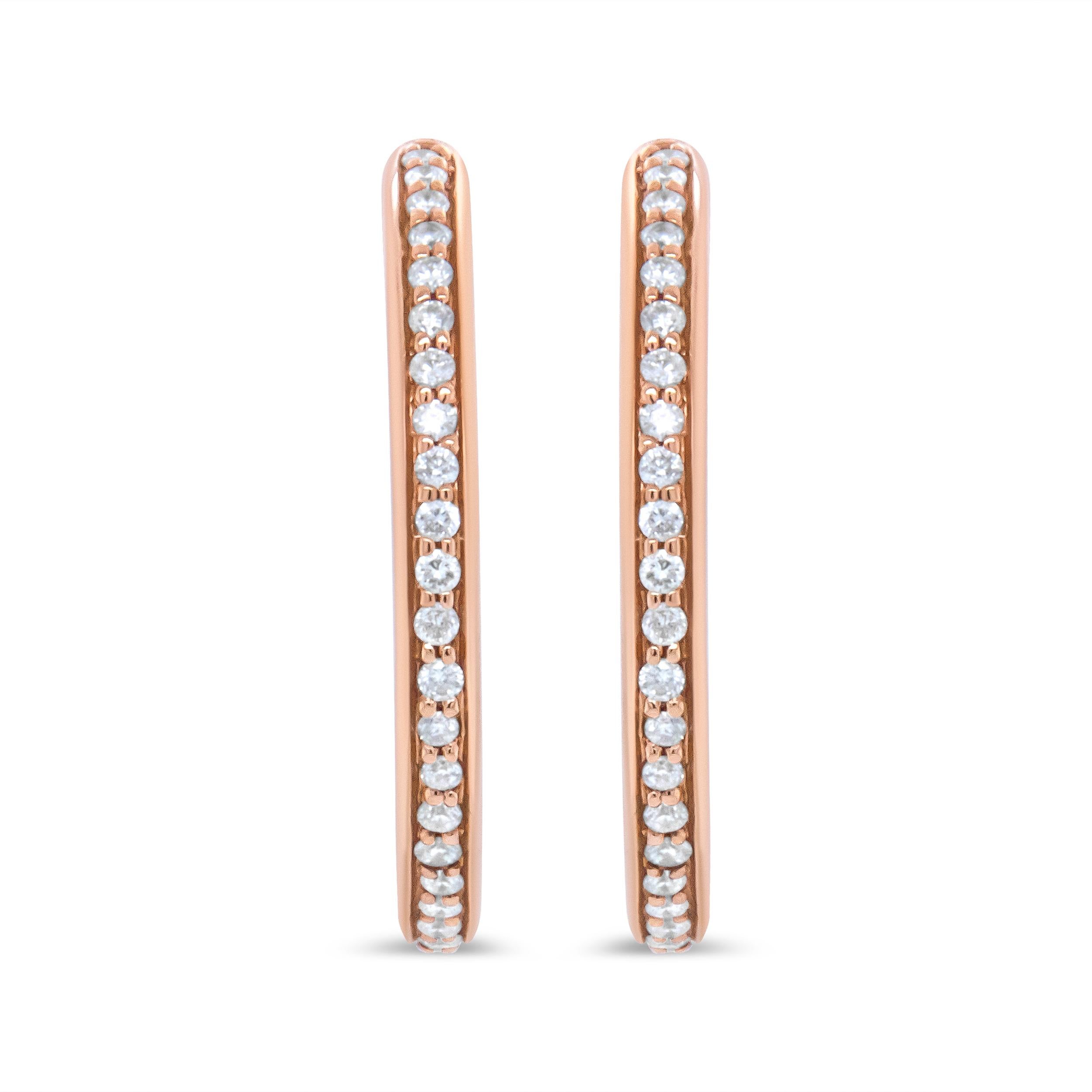 These classic hoops are a true romantic in genuine 18k rose gold with a total 1/5 cttw with an approximate F-G Color and VS1-VS2 Clarity. Each earring features a row of round, prong-set diamonds that flash a dazzling sparkle from your ears. These