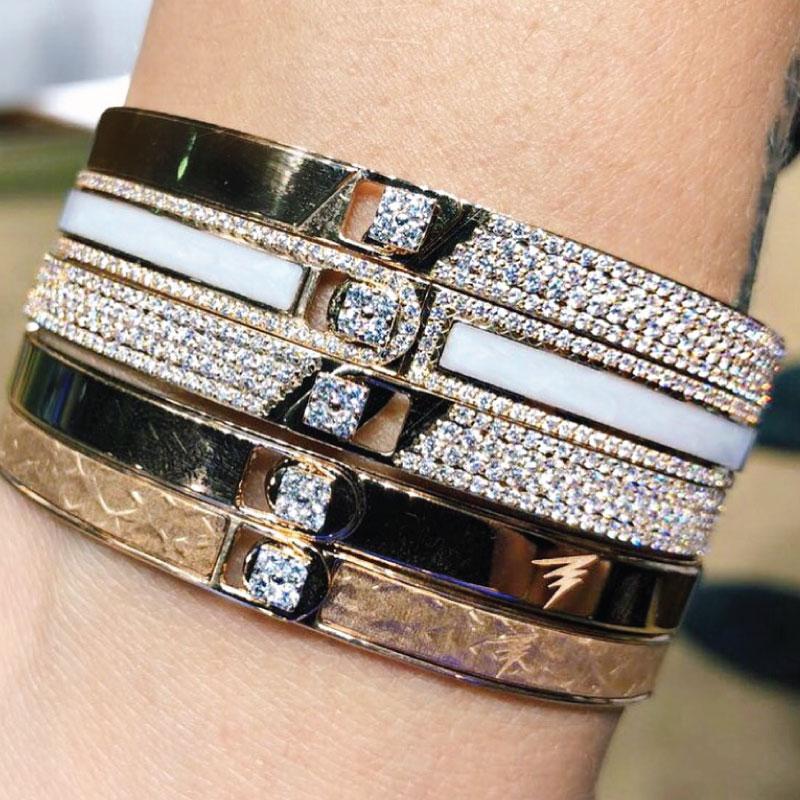 A ray of light, a band of colours, an illusion and journey on a wavelength. Iconic, bold and unique hand painted stackable designs. Add your personal touch to each design with your initials or a symbol.

Product Name: Half Pave Solid