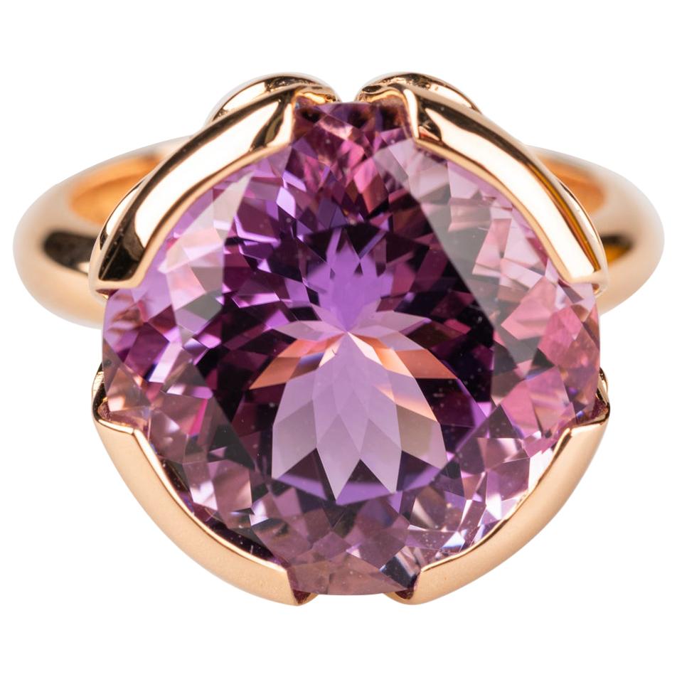 An 18k rose gold ring set with one round 12.32 carat lilac amethyst. Ring size 7. This ring was made and designed by llyn strong.