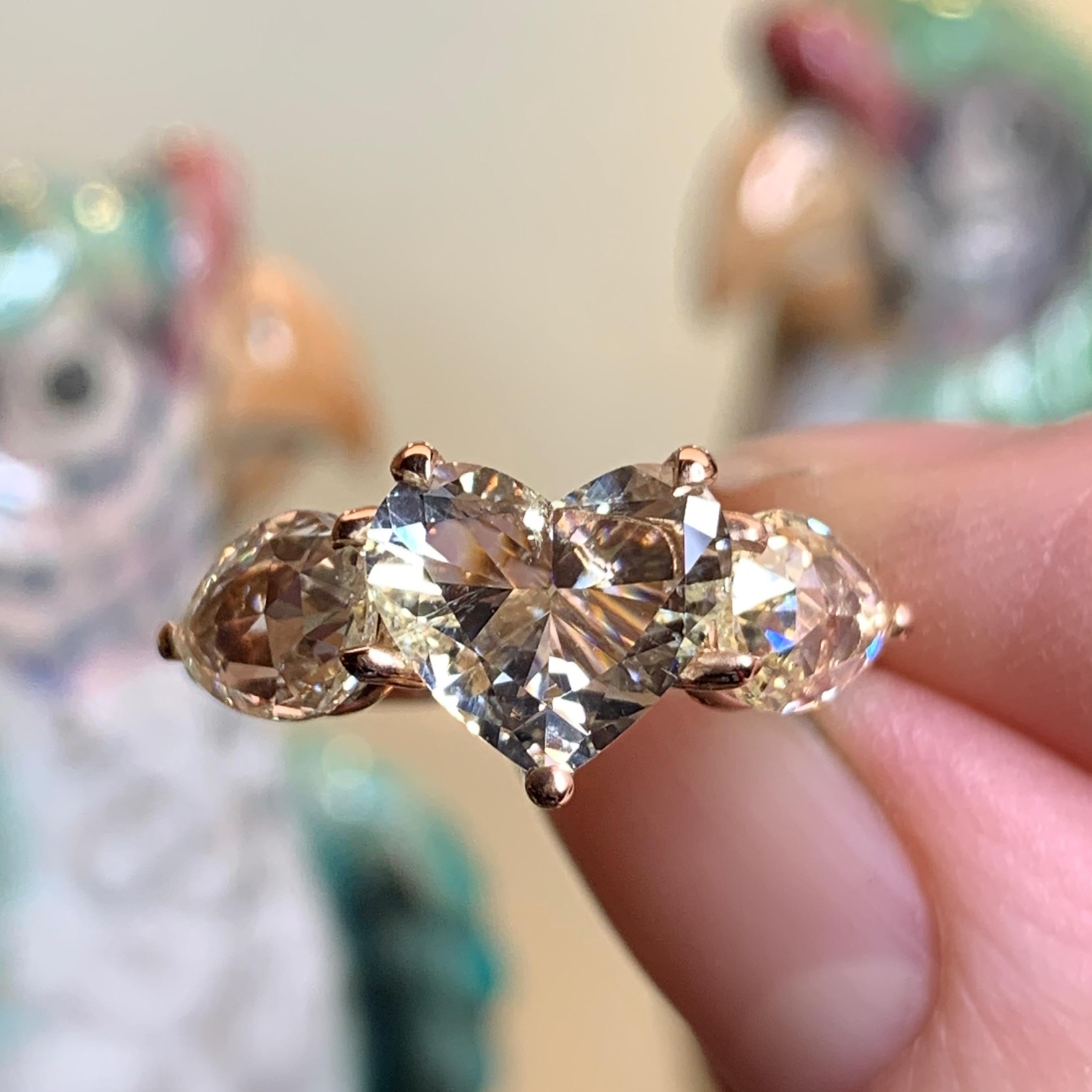 One of a kind ring in 18K Rose gold 6,44 g. set with a Heart shape diamond centerstone 2 carat ( K P1) and 2 Fancy light yellow pear shaped rose-cut diamonds VS Fancy light yellow) 2,88 carat. Total carat 4,91. Handmade the traditional way. size EU