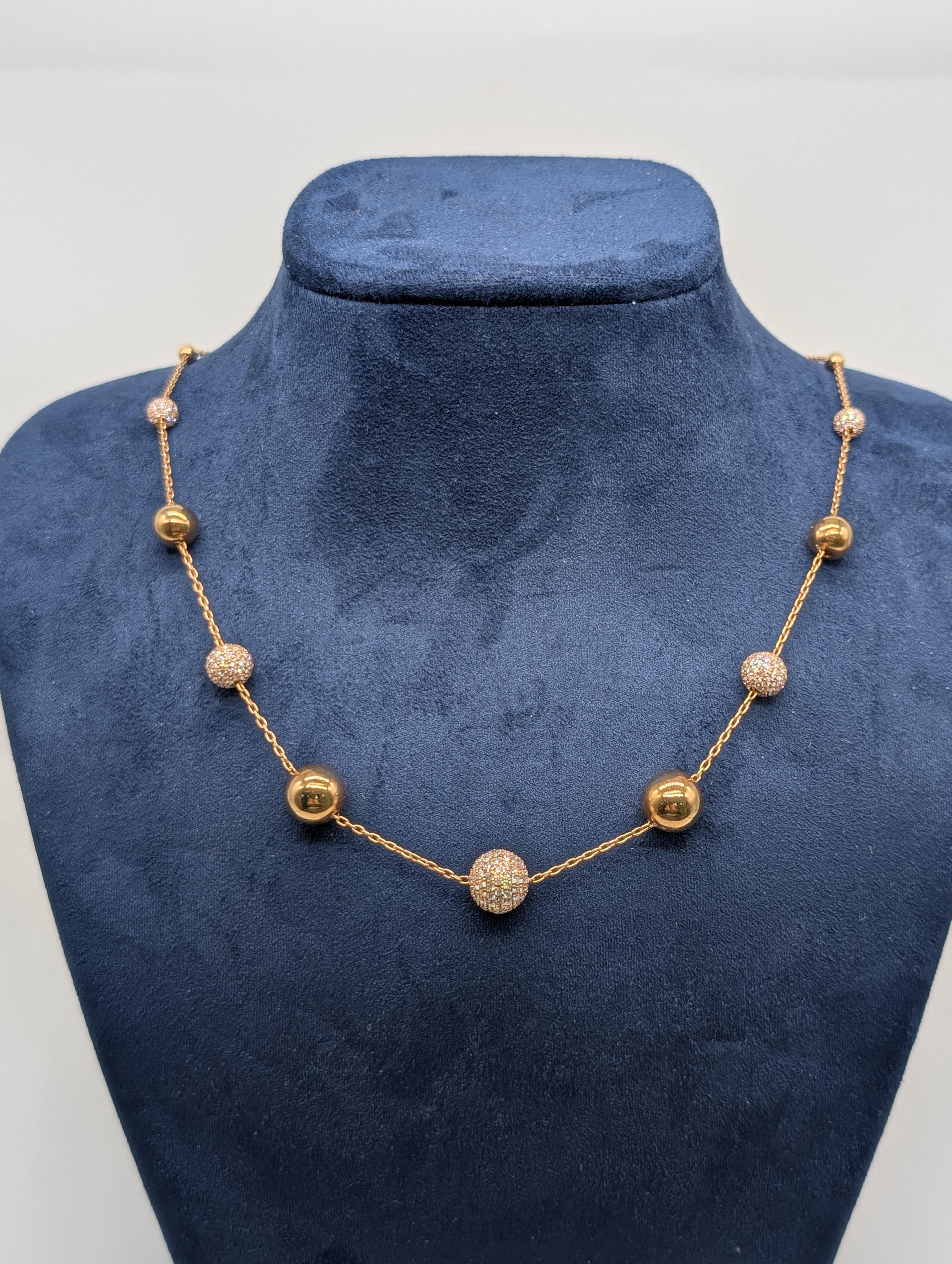 This stunning 18-karat rose gold necklace features graduated balls, each delicately designed to create a smooth, elegant flow. The necklace is adorned with brilliant round diamonds totaling 2.99 carats, adding a touch of sparkle to the warm glow of