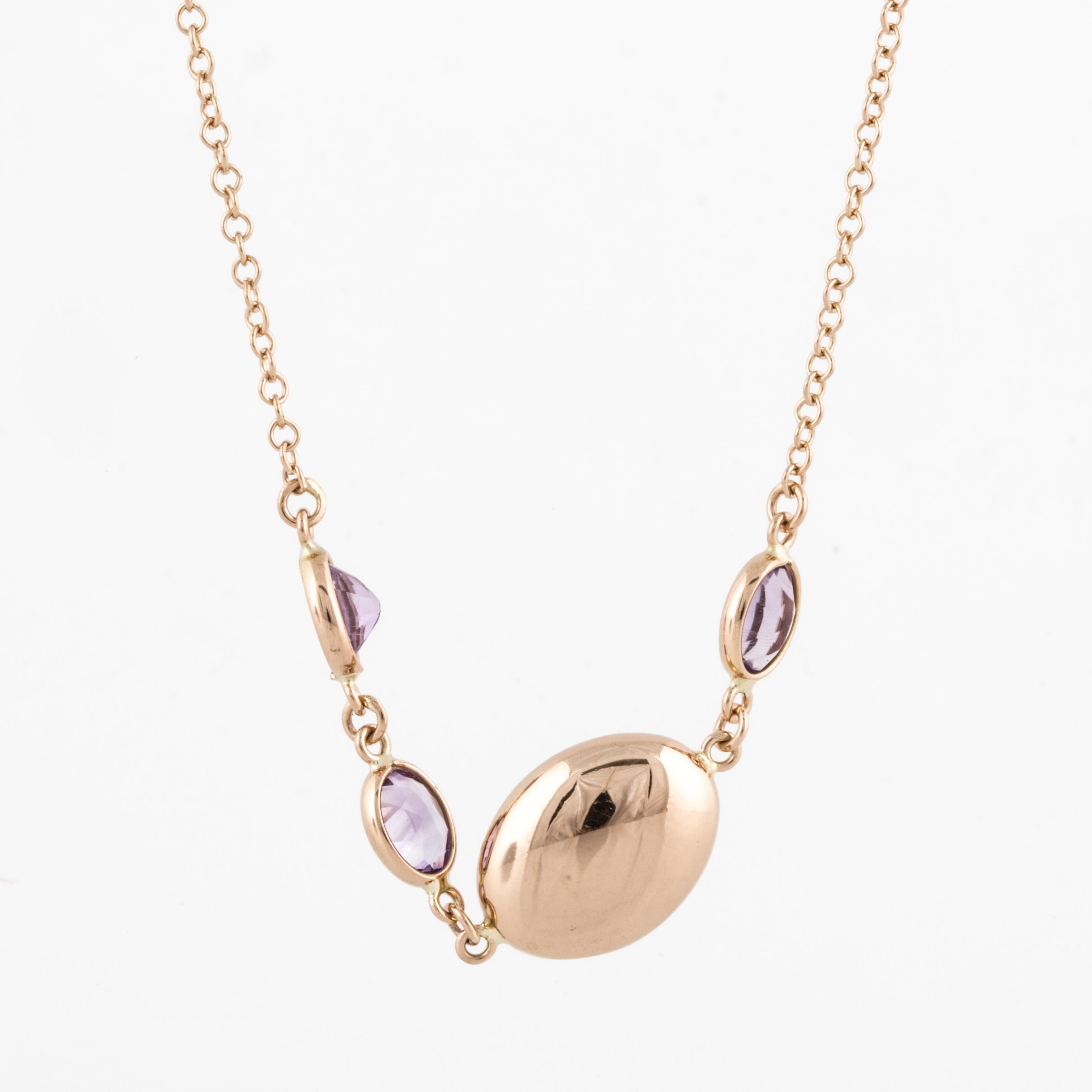 18K rose gold necklace with amethyst stations.  There are a total of 36 faceted amethysts.  Interspersed are oval puffy gold spacers, both large and small.  Measures 45 inches long.