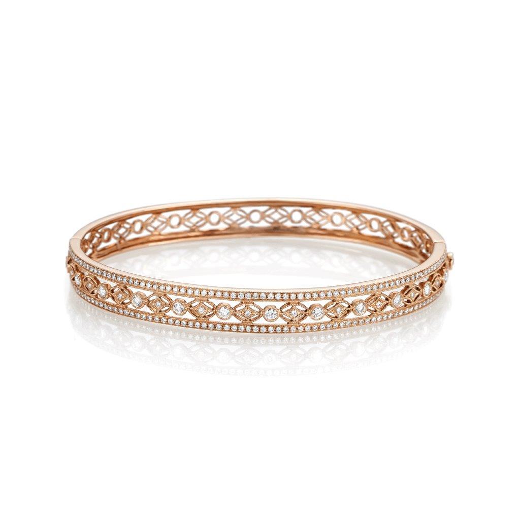 Heritage bangle bracelet, crafted in 18k rose gold. With intricate details of millegraining and hand-engraving, this bangle features 190 round brilliant cut diamonds weighing a total of 1.35ctw. G-H color and VS-SI clarity.  