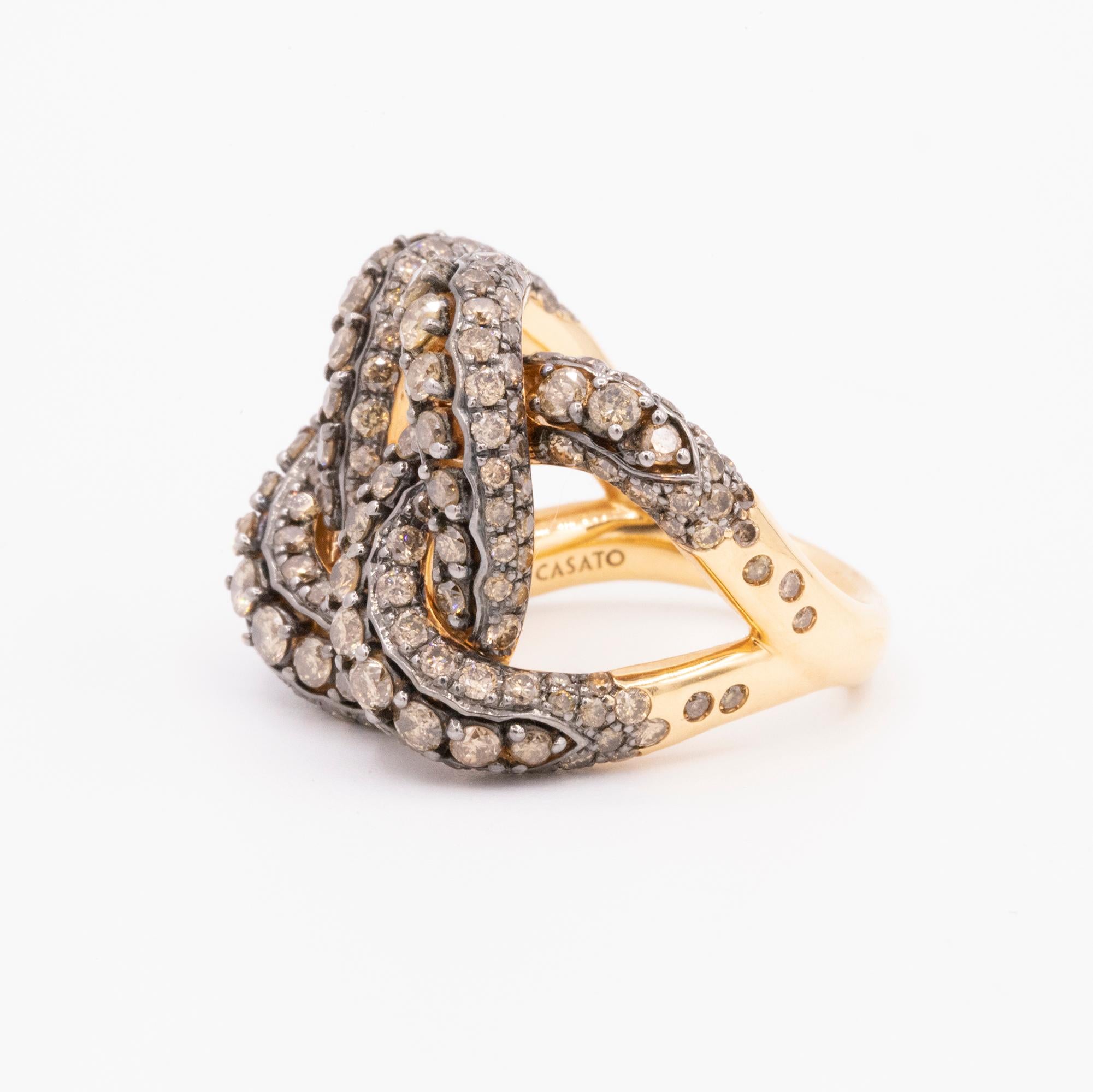 This modern ring is handcrafted in 18k rose gold for a knot design look. 230 round brown diamonds are pave set weighing 3.93 carats total. Split shank.