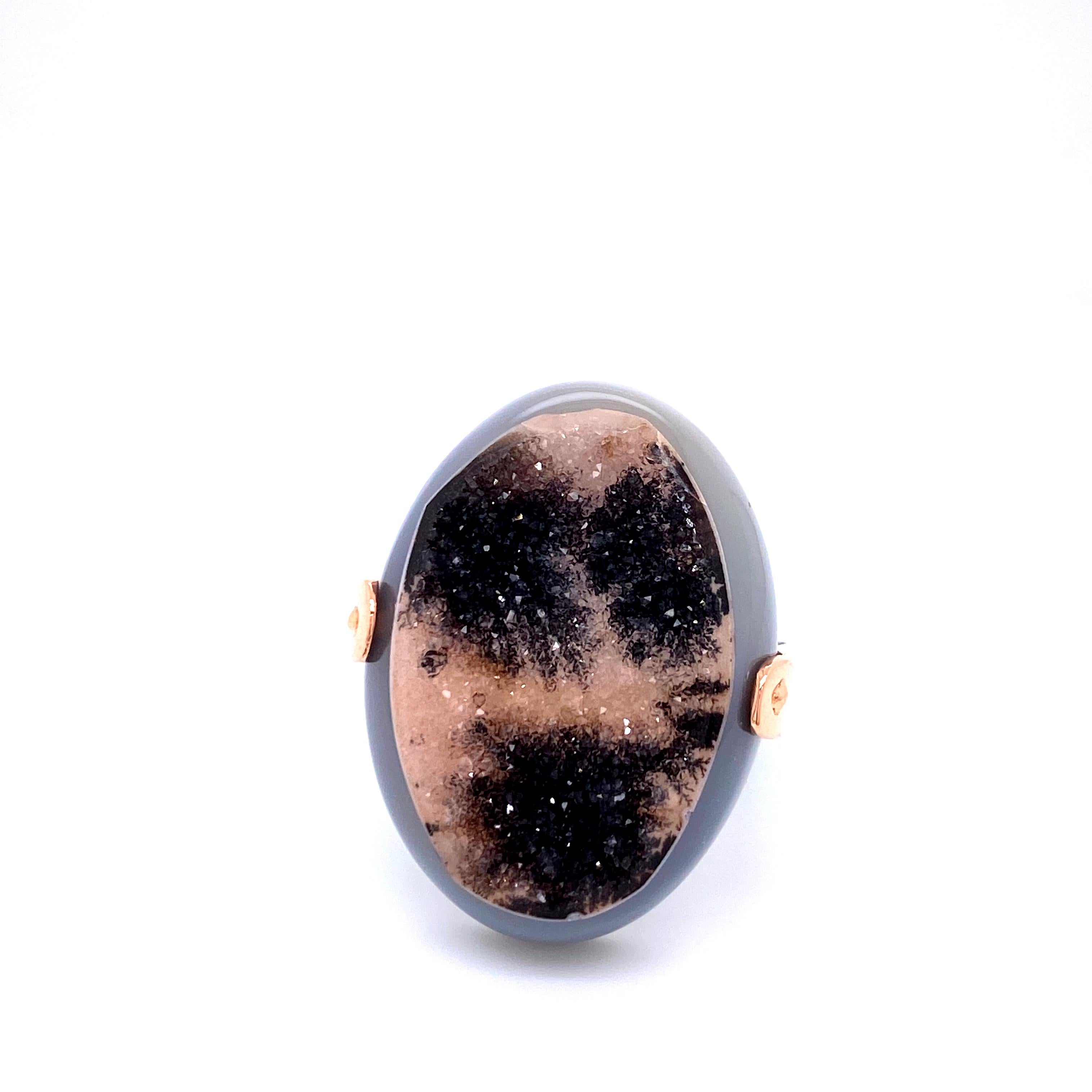 An 18k rose gold and oxidized sterling silver ring featuring one oval shaped druzy quartz- black and grey.Ring size 9.5. This ring was custom designed and made by llyn strong.
