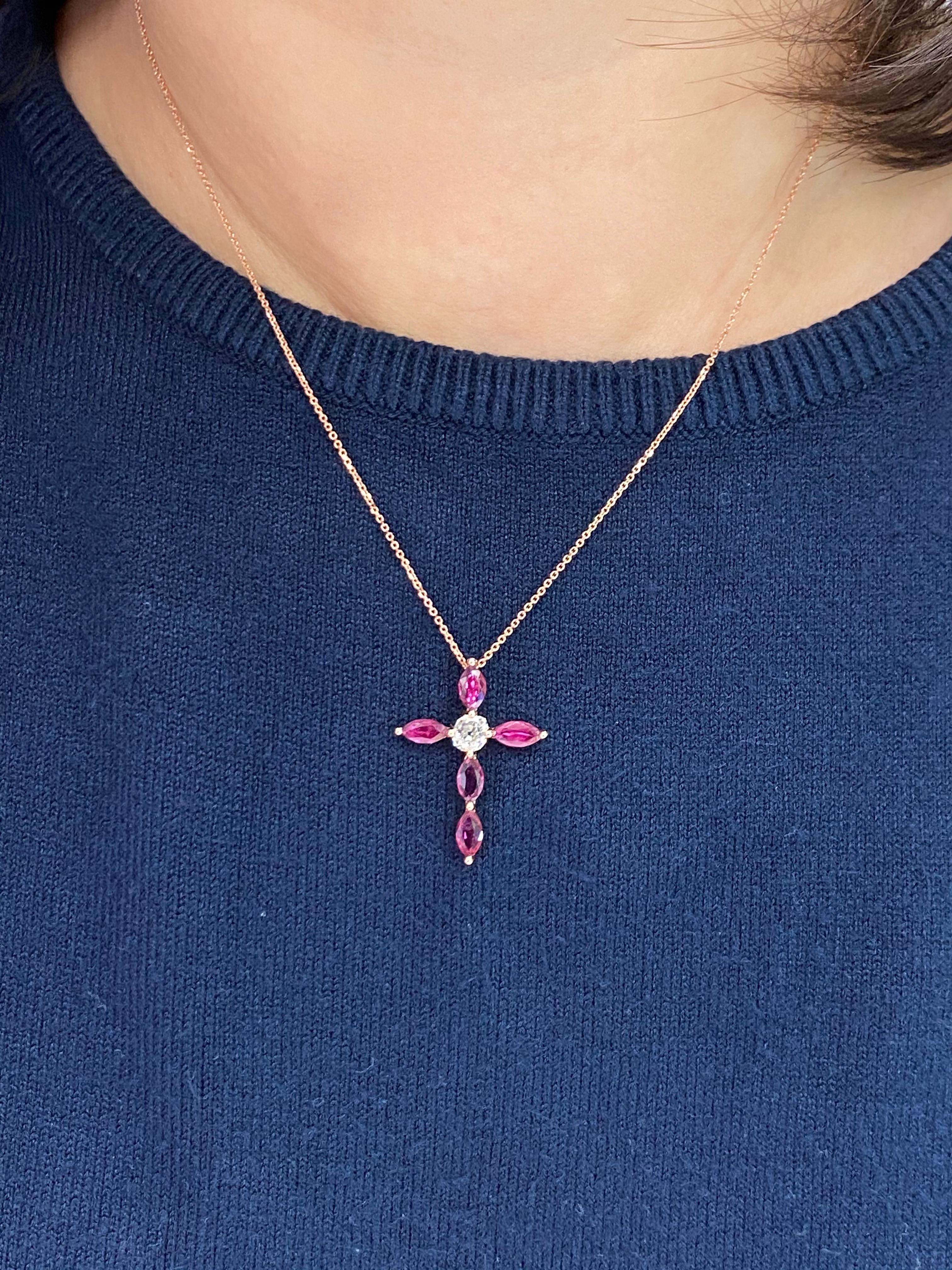 This is a beautiful classic cross pendant. It is set in 18k Rose gold and one true antique old mine cut diamond. In the center is one antique OMC diamond 0.35 cts. There are 5 Marquis shaped Burma rubies with a total carat weight of 1.53cts that
