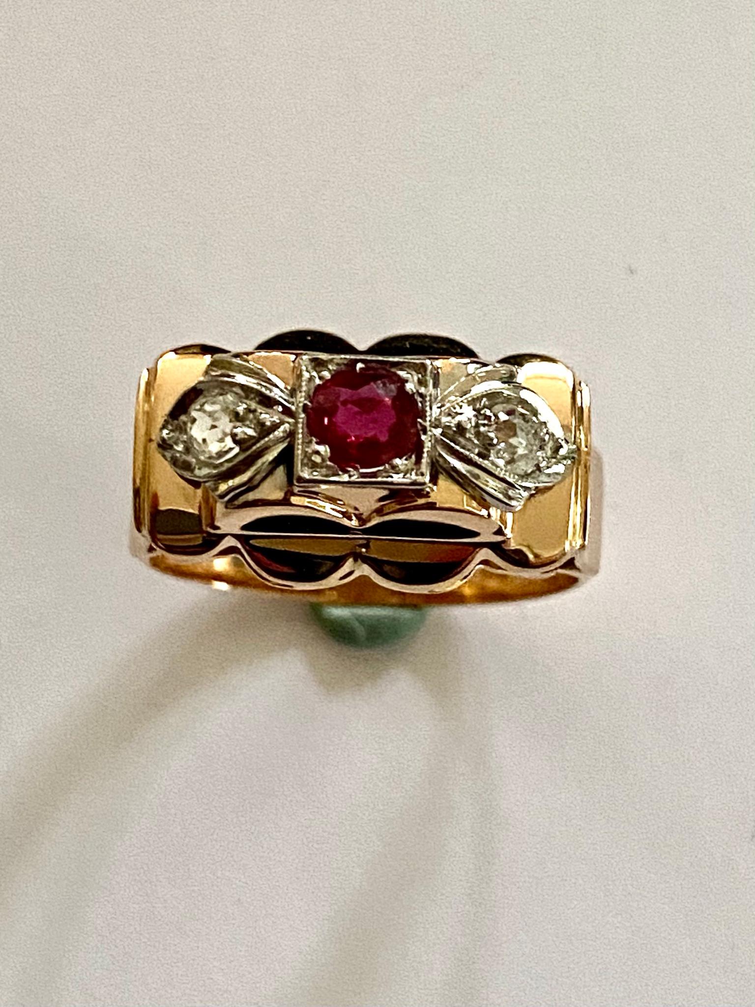 One (1) 18 Karat Rose Gold Ring,, stamped 750
One  Natural Corundum RUBY 0.29 ct.  Vived Red.
Tw0 Old mine Cut diamonds (1940)  each 0.10 ct.  VS/ F
Weight of the Ring: 3.55 grams.
Measurment of the head of the ring:   17 x 10 x 6 mm.
stamped: 0.750