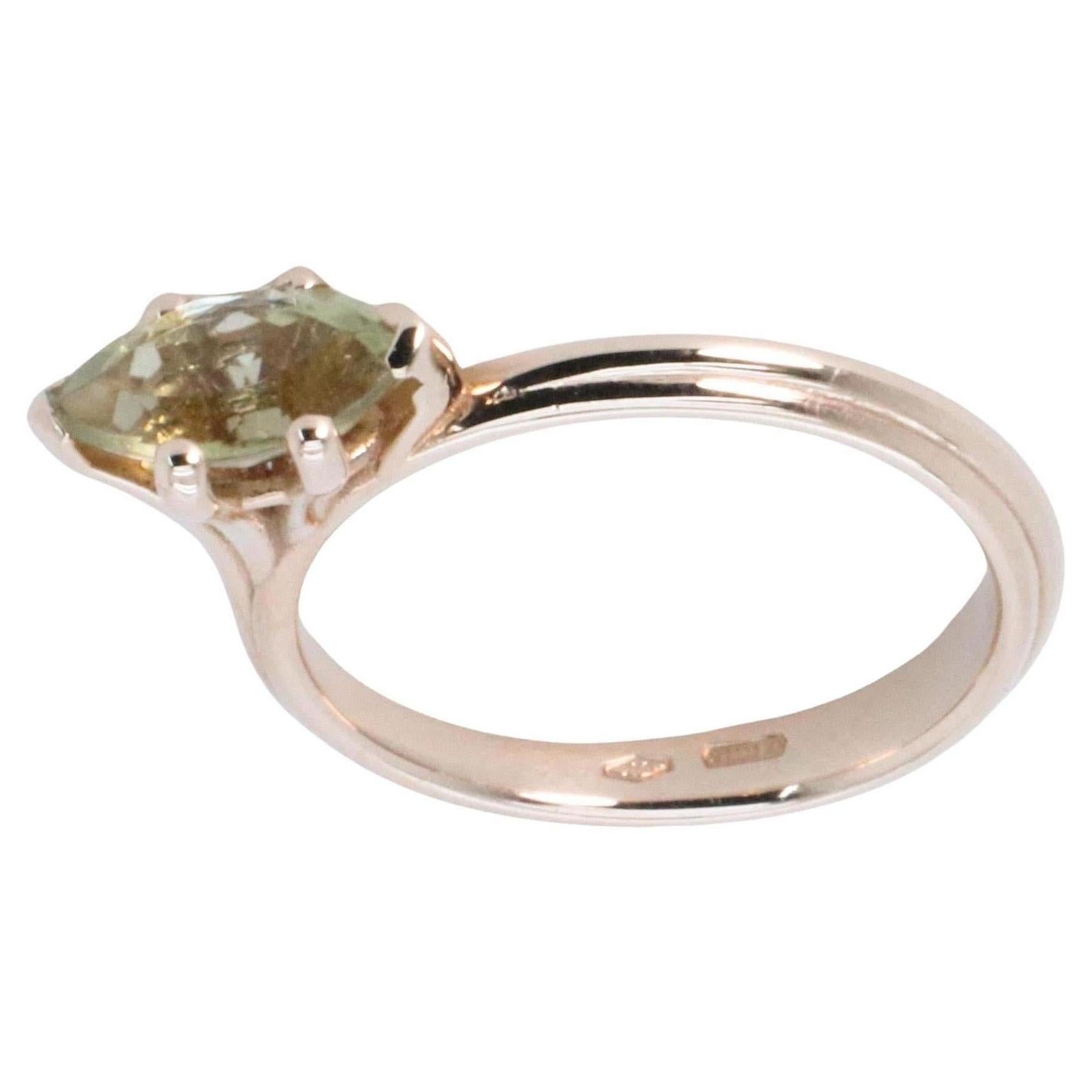 18K Rose Gold Asymmetric Cosmic Design Stackable Green Tormaline Cocktail Ring.
The Egle ring is made of 18 karat rose gold and features a marquise mixed cut natural light green tourmaline around 1.09 carats, which measures 4.7 mm by 11 mm by 3.7