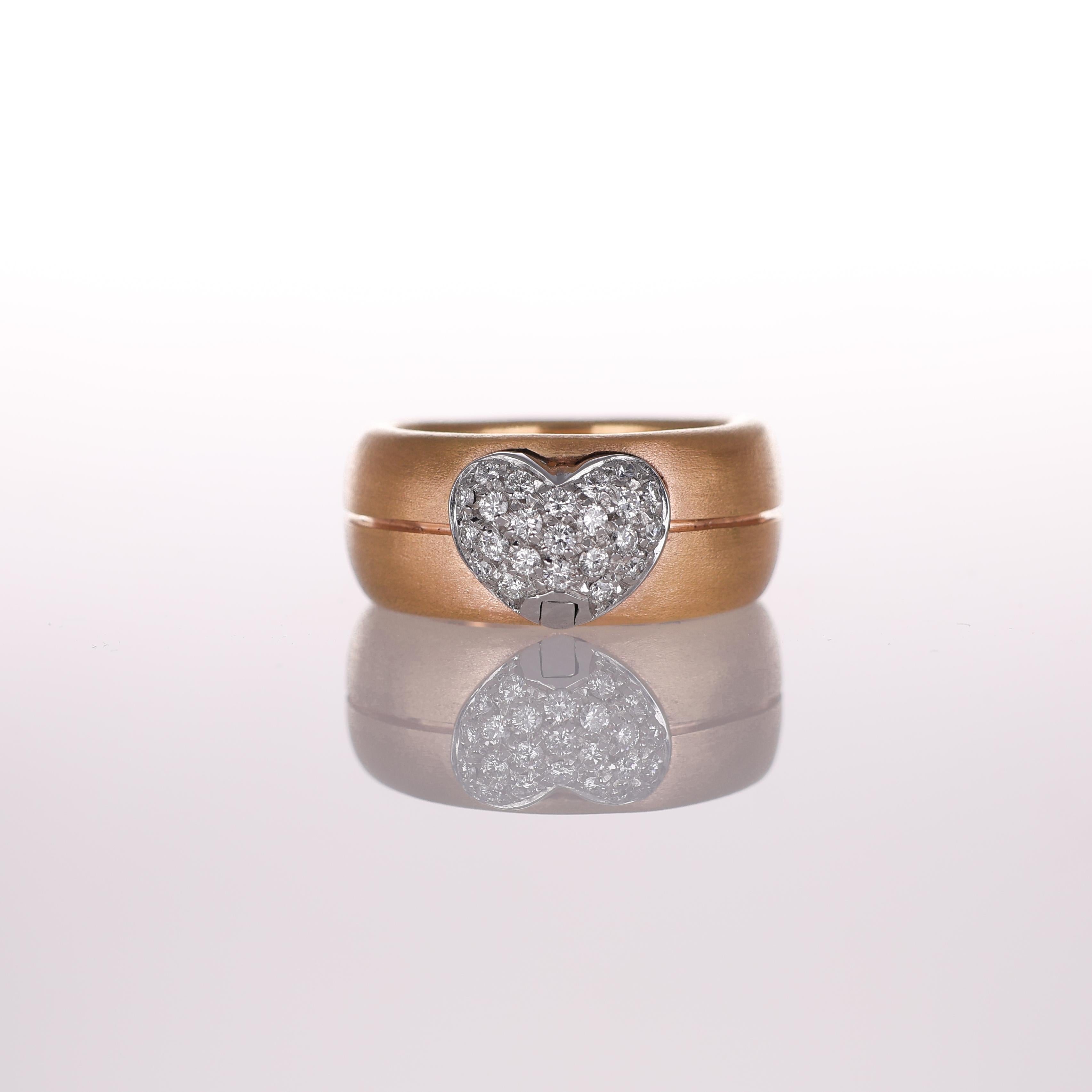 A bold and romantic band ring crafted in 18K rose gold, featuring a central heart motif adorned with a pavé of diamonds totaling 0.35 carats. The brushed finish of the gold enhances the contrast with the brilliance of the diamonds, creating a