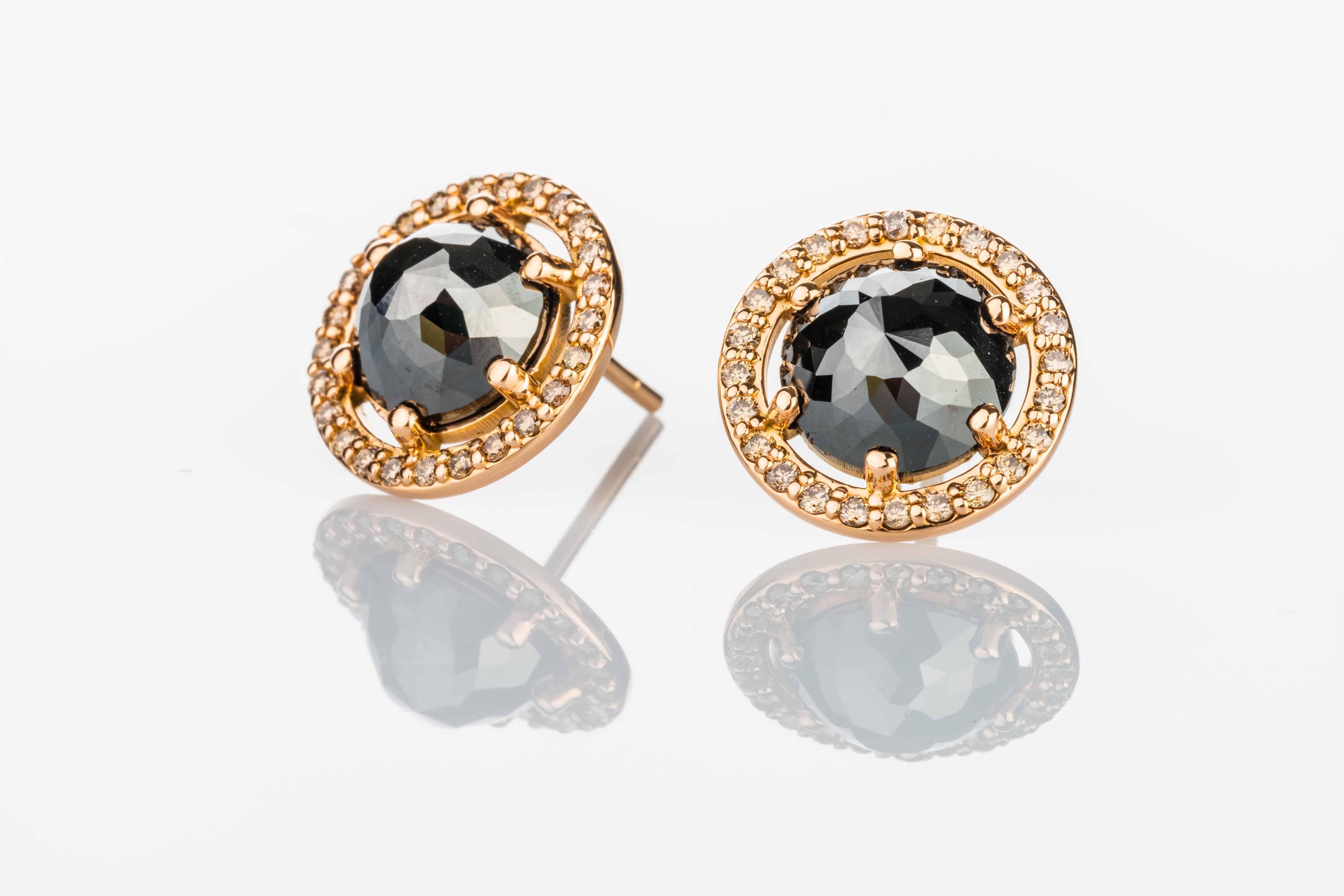 18k rose gold stud earrings with two rose cut black diamonds 3.8 total carat weight and 49 1.25mm champagne diamond halo .36 total carat weight. These Studs were made and designed by llyn strong.