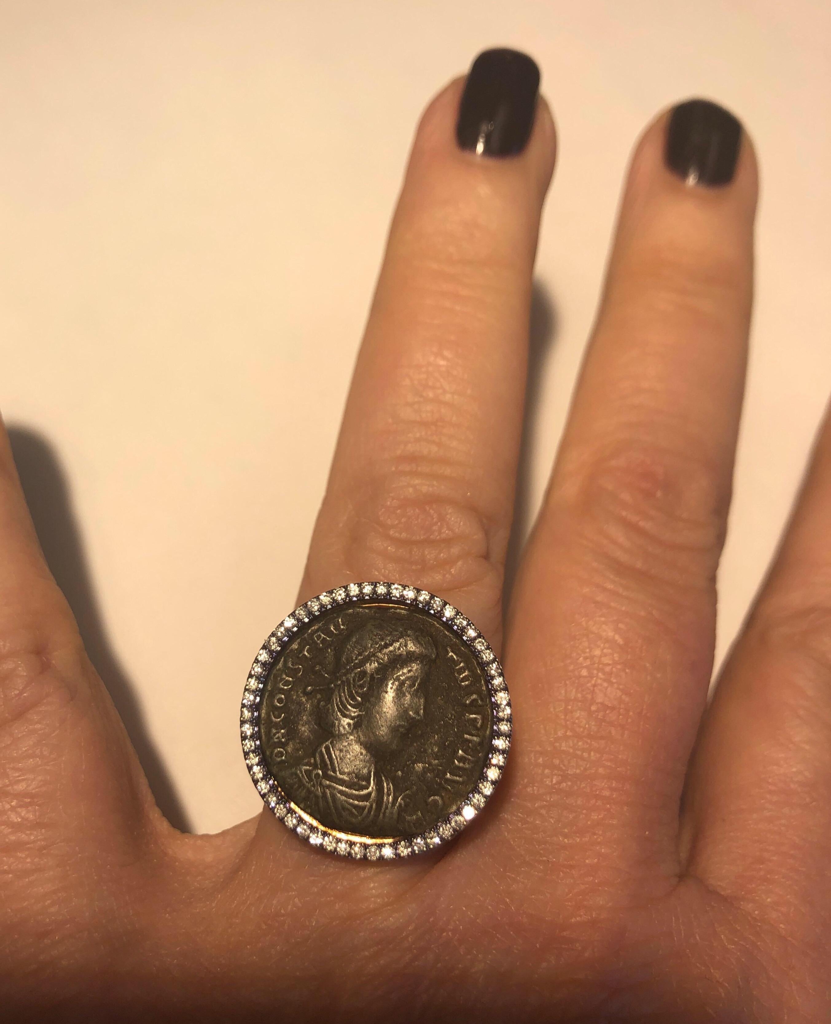 18K rose gold ring set with bronze ancient Roman coin surrounded by full cut round diamonds and diamonds partway down shank weighing .45cts .

Retail $3750
Finger size 5.75, may be sized