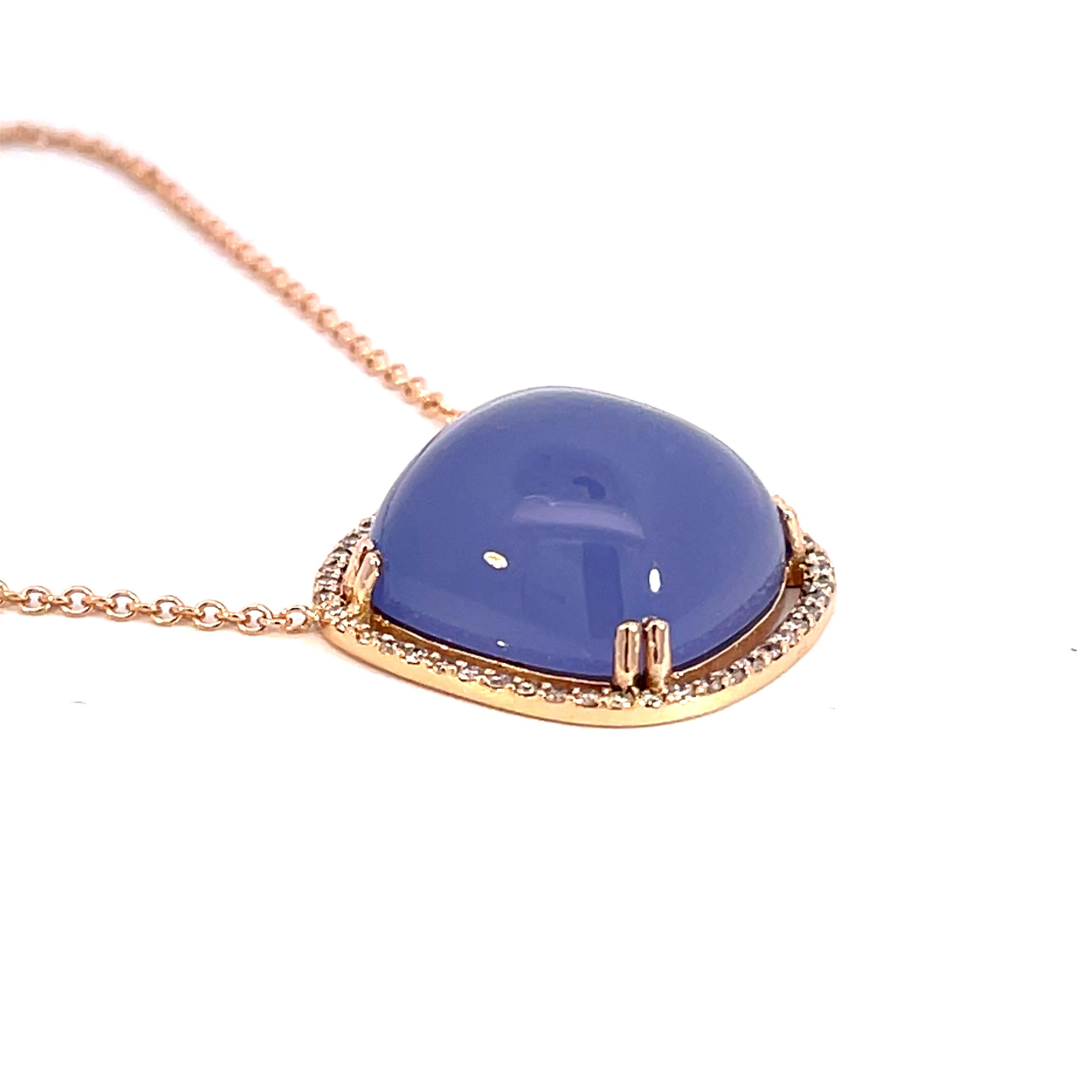 An 18k rose gold pendant featuring one double prong set cushion cut cabochon blue chalcedony 22.14 carats and accented by a halo of white F color VS clarity diamonds 0.30 total carat weight on a 1.5mm 14k rose gold cable chain. This necklace was