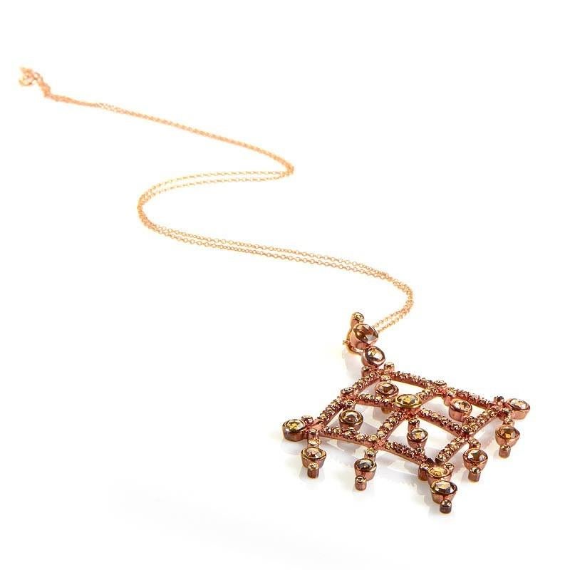 This pendant necklace is opulent and shines with diamonds It is made of 18K rose gold and boasts a diamond shaped openwork pendant. The pendant has a fabulous design that features ~2.75ct of champagne diamonds.

