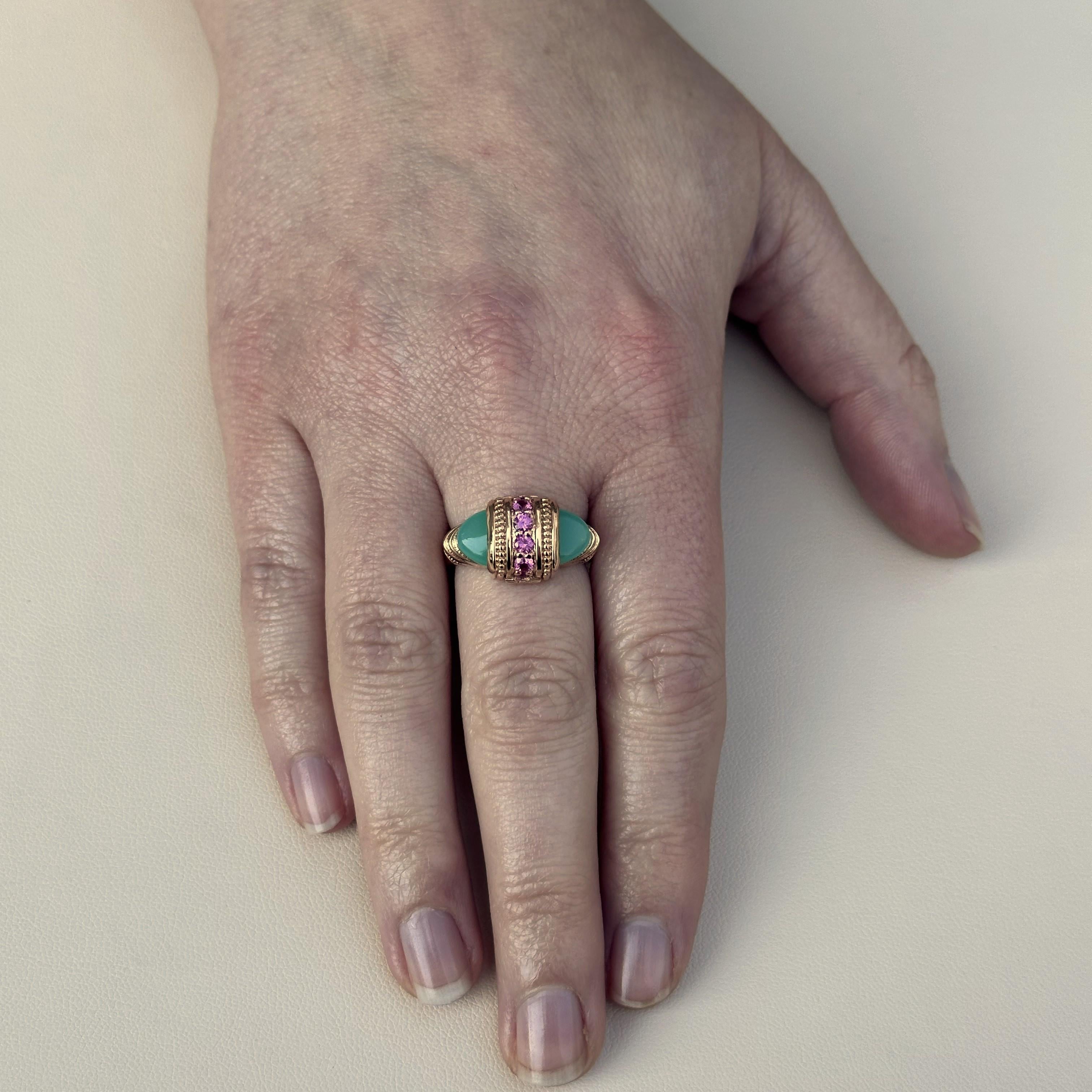 An 18k rose gold arch-style statement ring with cabochon cut chrysoprase and 2.5mm pink sapphires. This ring was designed and made by llyn strong.