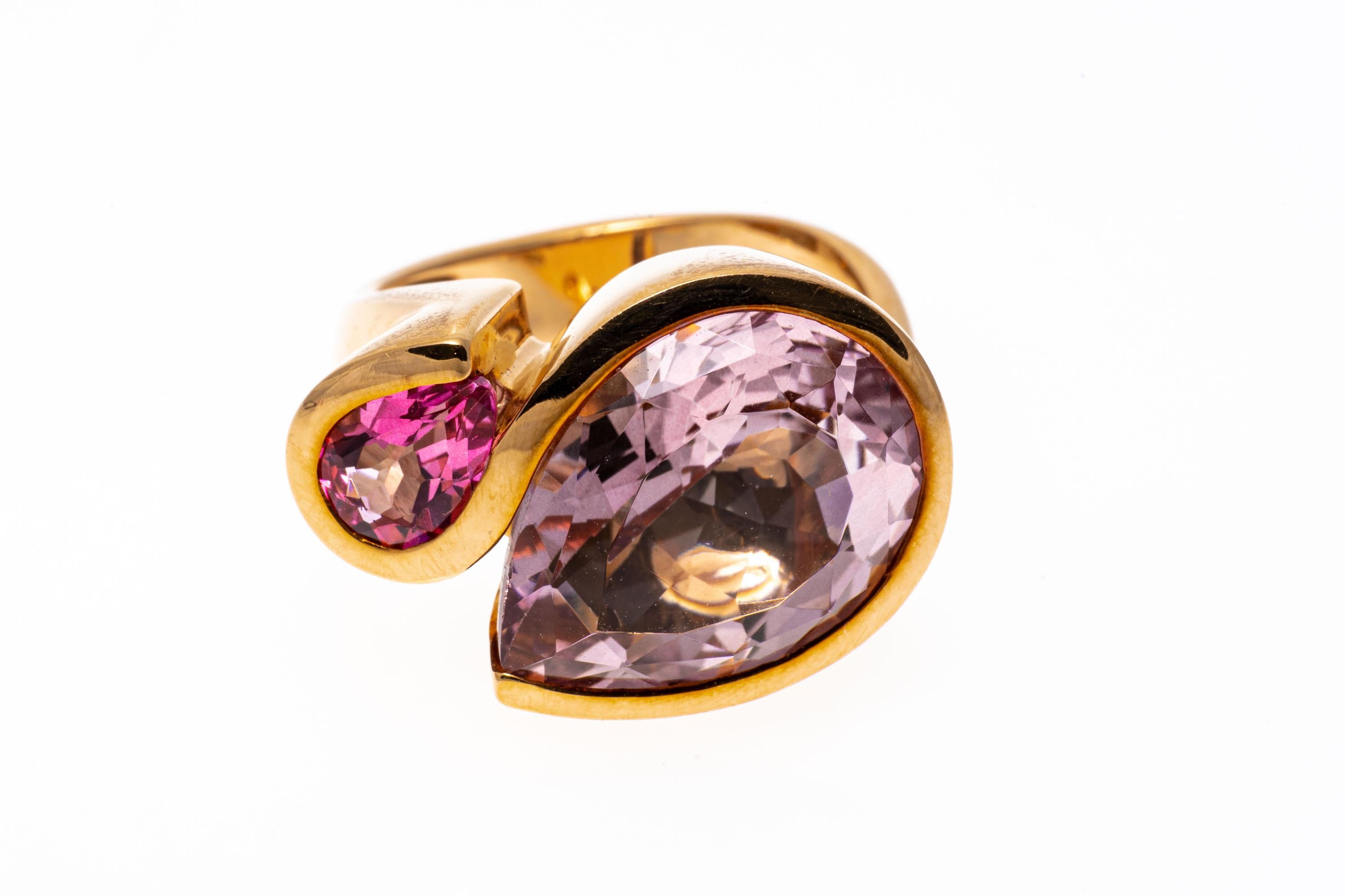18k rose gold ring. This lyrical ring is a contemporary, bypass style with a large, pear shaped faceted, pale pink color pink tourmaline, approximately 5.79 CTS and 3/4 bezel set, offset by a small, pear shaped faceted, bright pink color pink