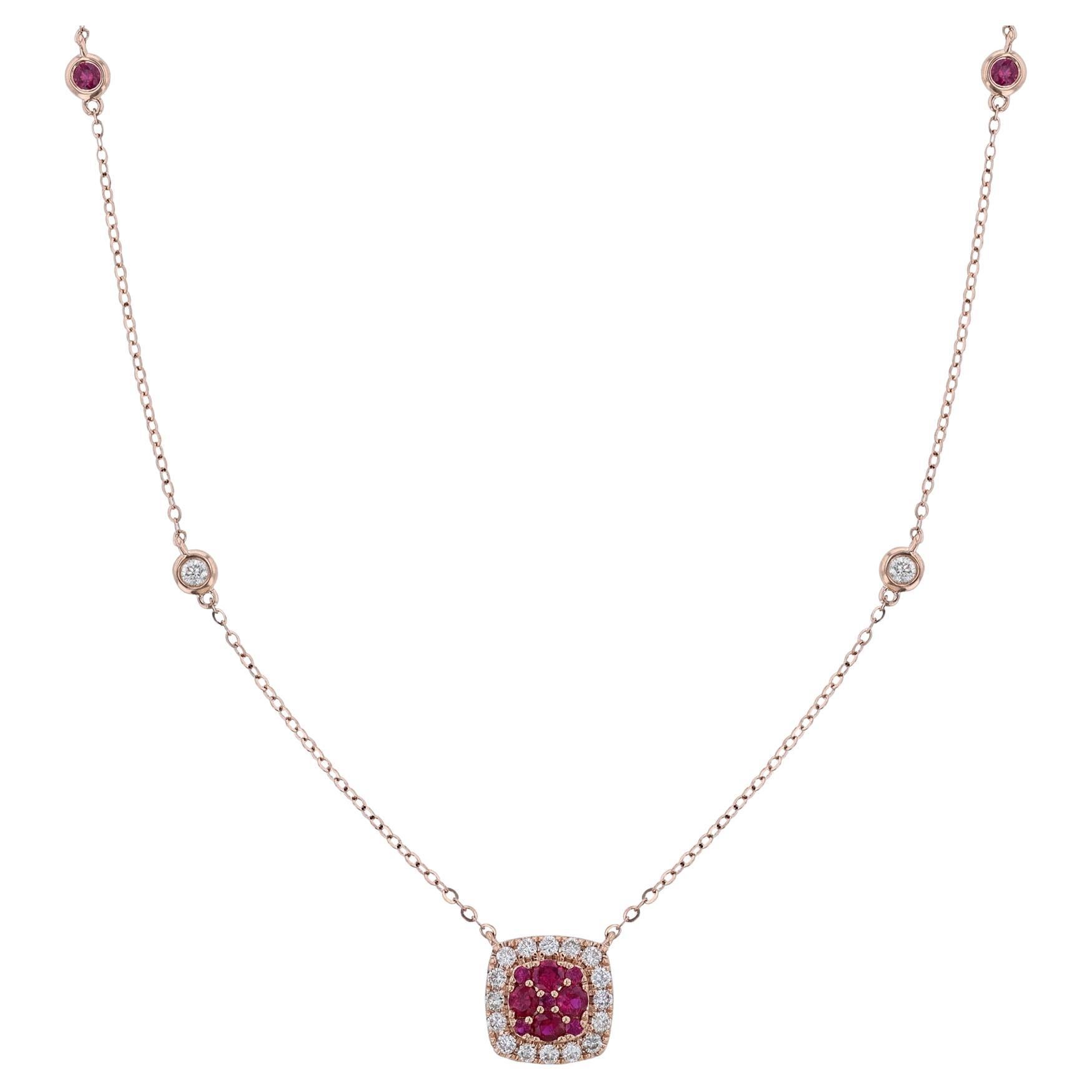 This pendant necklace is made in 18K rose gold. It features a cushion shape pendant with 9 round cut, center rubies. Surrounded by a halo of 16 round cut diamonds. With 2 round cut, bezel diamonds stations, and 2 ruby bezel stations. The necklace