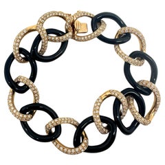 Gliederarmband aus 18 Karat Roségold mit Diamanten und Onyx