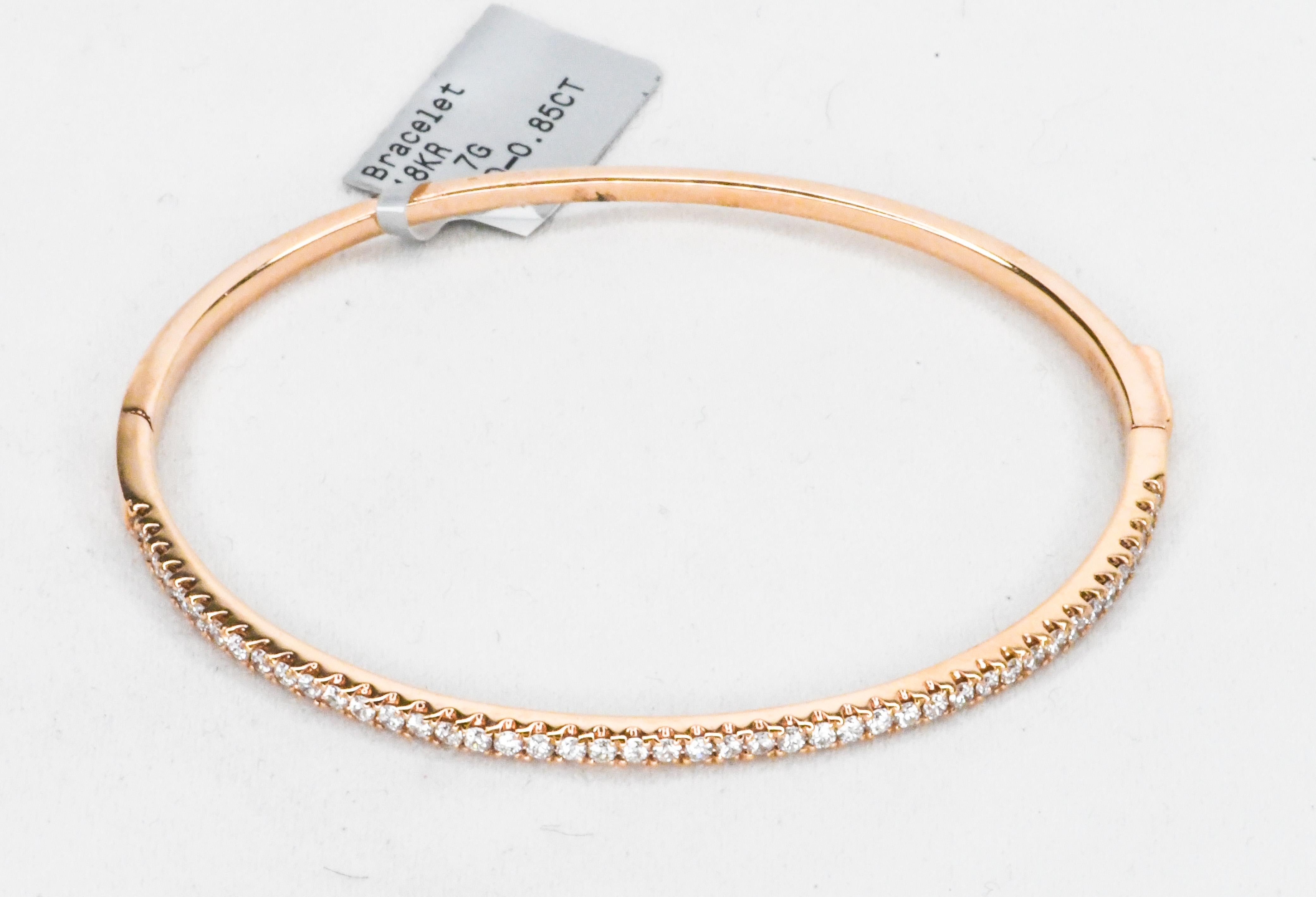 Rose Gold has a warmth that looks great on all skin tones.  Rich color!  This bangle bracelet has a clamper clasp that will click twice for security.  Top is a single row of beautifully matched white diamonds having a total weight of 0.85 carats. 