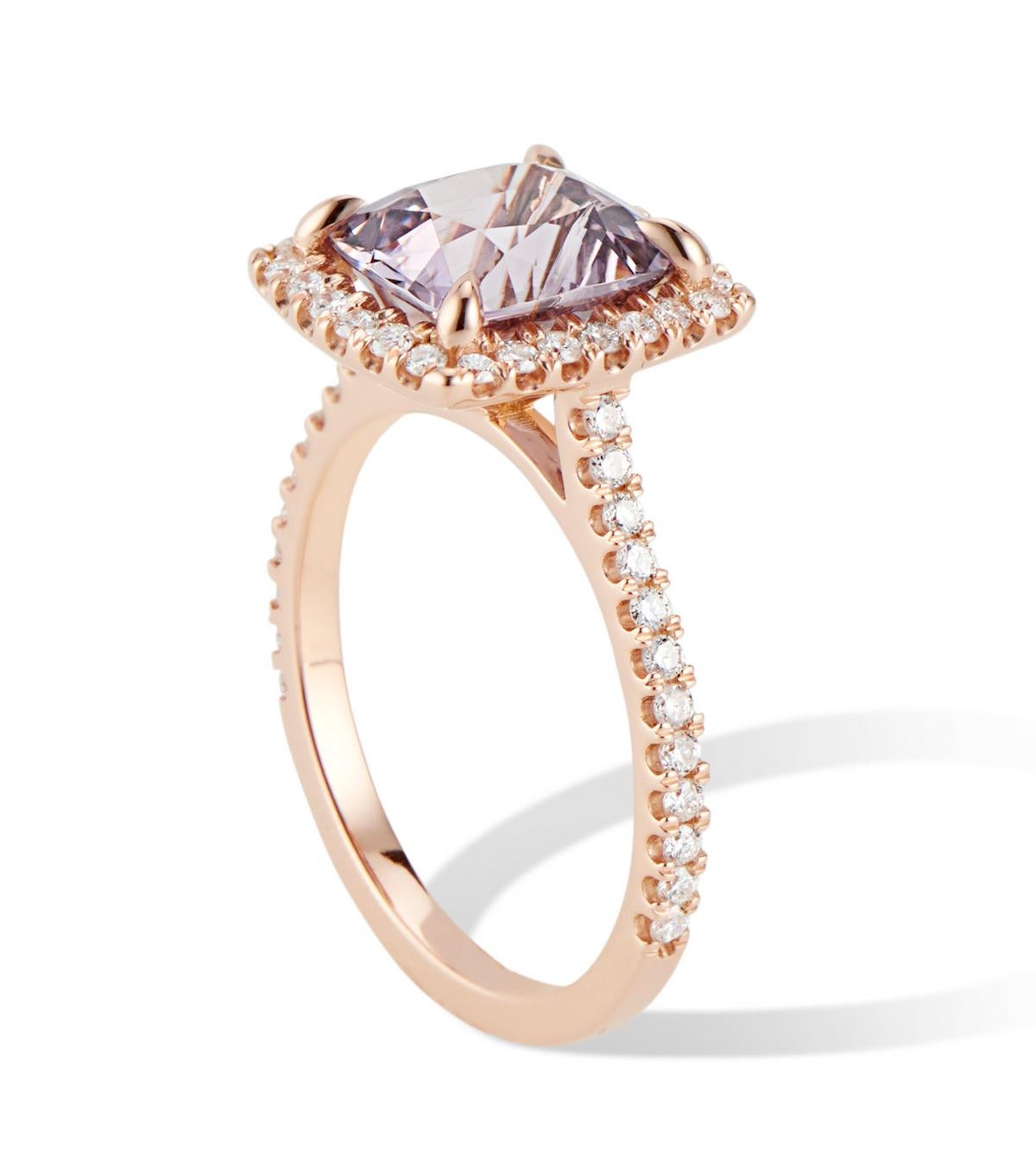3.03 tcw. Lavender Spinel surrounding by a halo of scintillating VS quality diamonds. 
The diamond setting is handmade, adding to the quality details of this piece. 
The Sparkle and Dance of the gemstones complement the soft hue of the high polish