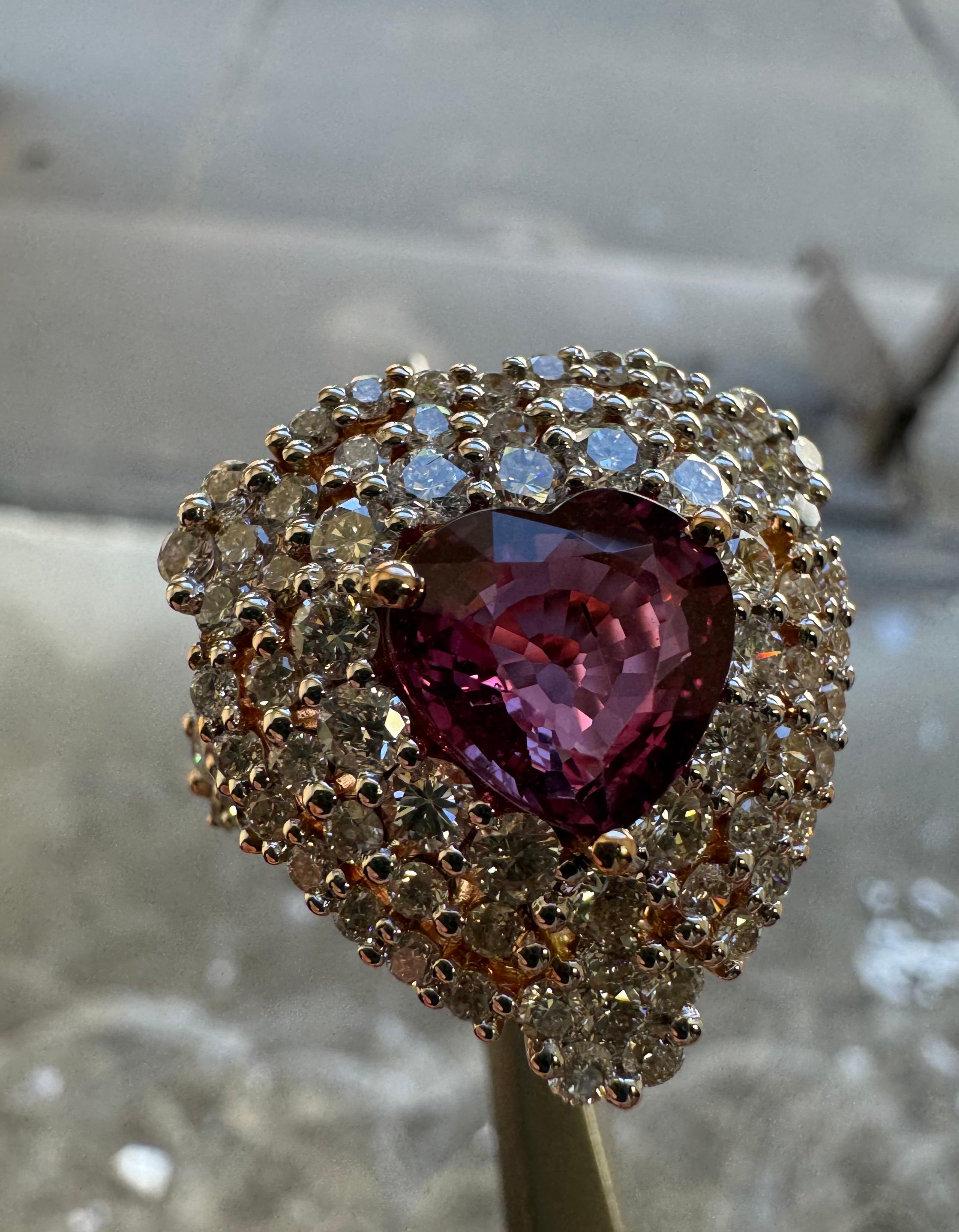 DeKara Design Collection 

Metal- 18K Rose Gold, .750. 

Stones- 1 GIA Certified No Heat Heart Shape Pink Sapphire 3.50 Carats, 91 Round Diamonds G-H Color VS2-SI1 Clarity 2.63 Carats. 

GIA Sapphire Report Number 2235339897

Size- 8.  Free