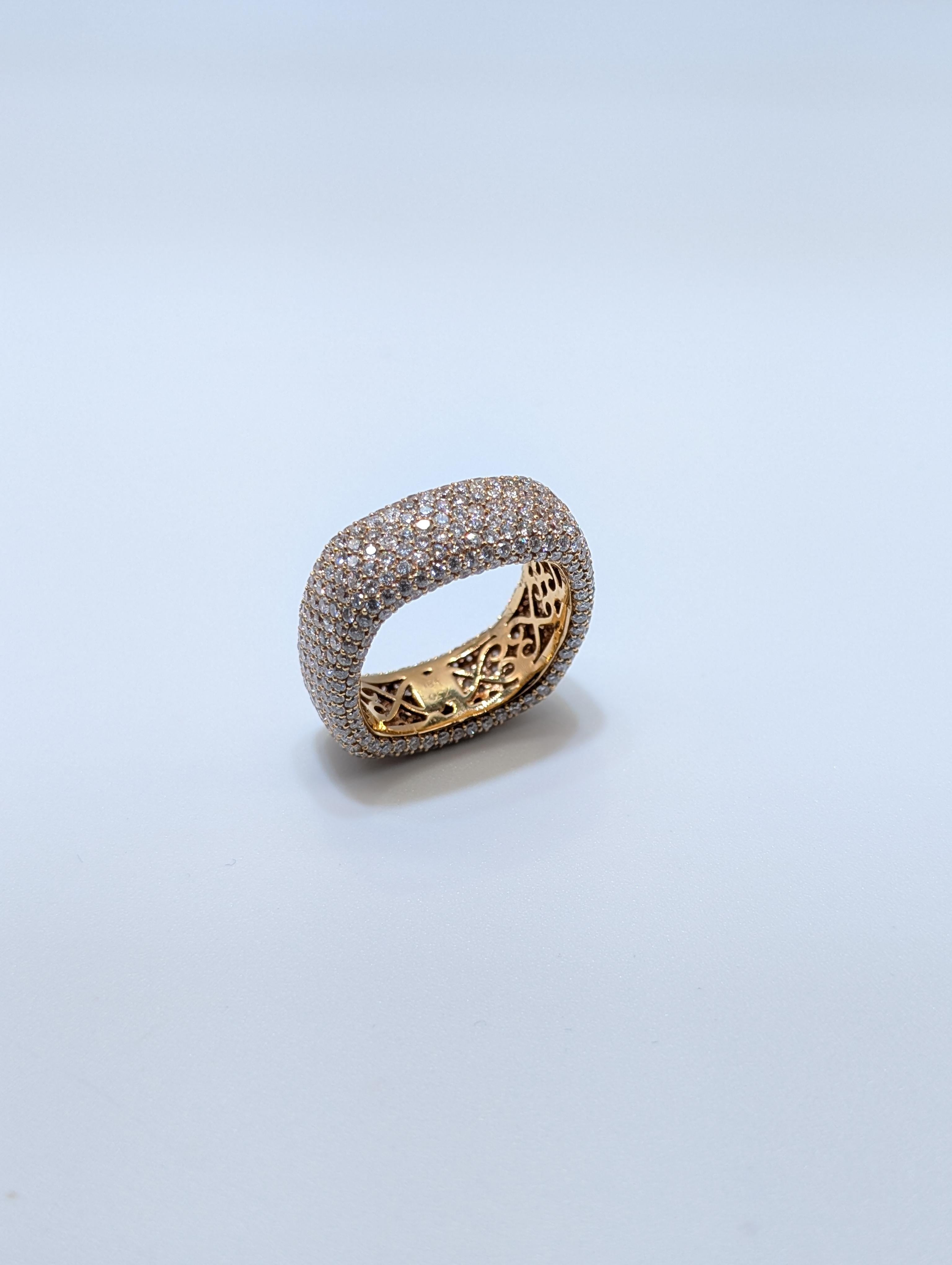 This stunning ring is crafted in luxurious 18k rose gold and features an opulent pavé setting of diamonds that envelops the entire outer surface. With a total diamond weight of 4.25 carats, the ring radiates brilliance from every angle. The interior