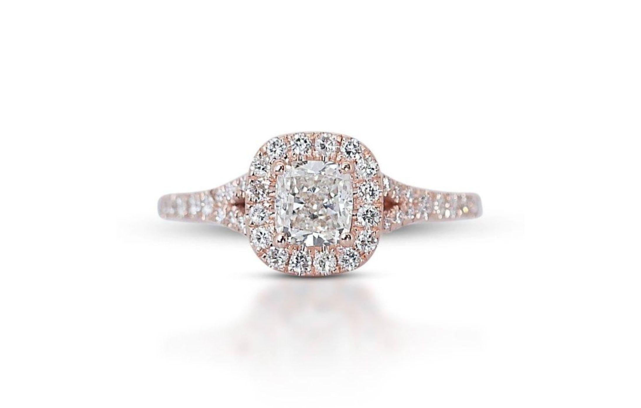 Prepare to be captivated by a ring that whispers tales of blushing rose petals kissed by morning dew. This breathtaking creation features a dazzling 0.7 carat cushion-cut diamond, its G color radiating pure, luminous beauty with a hint of romantic