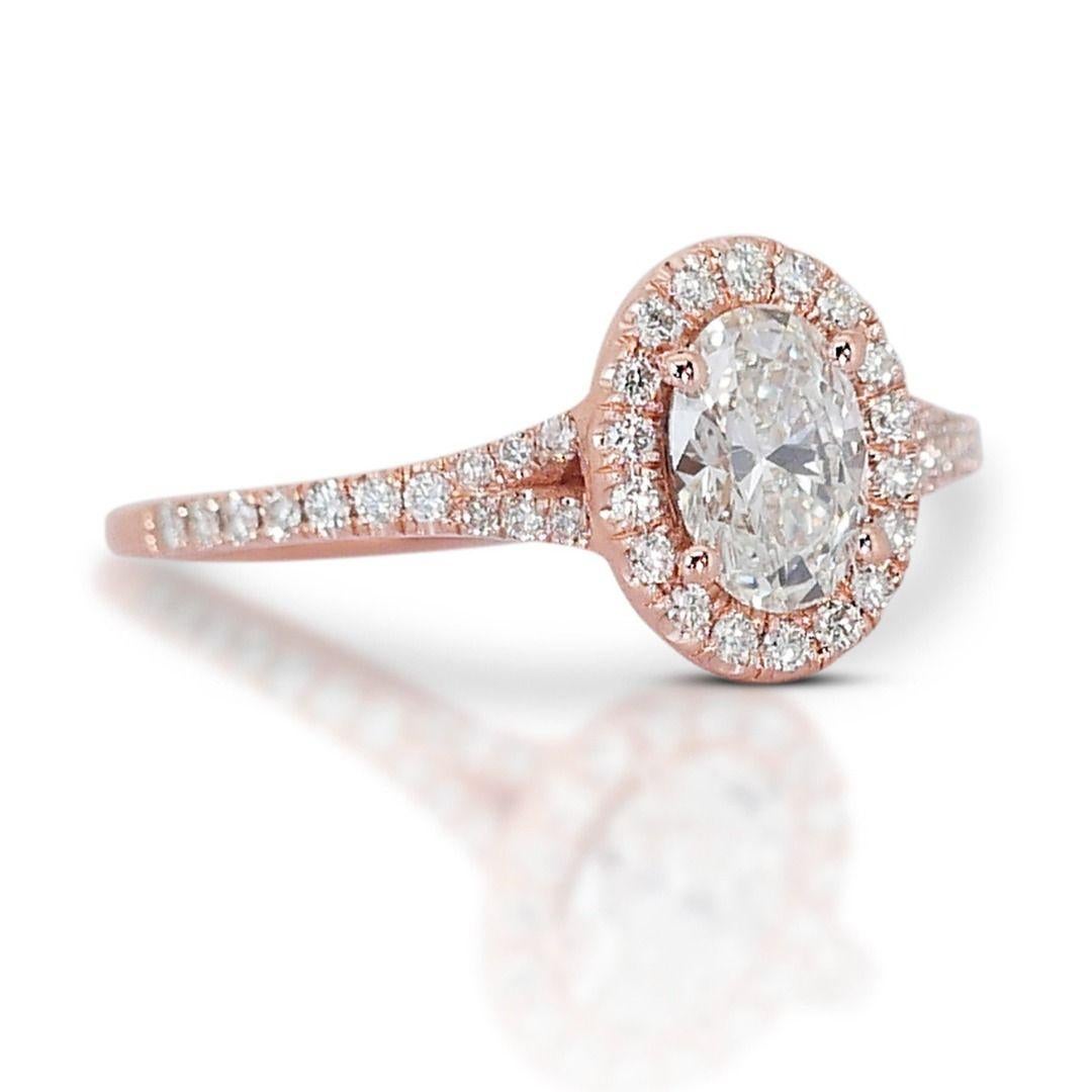 Embrace the captivating blush of a sunrise captured in this enchanting ring.
At its heart, a dazzling 0.73 carat oval diamond shimmers with the delicate glow of the first rays of sunlight. The exquisite oval cut dances with every glimmer, showcasing