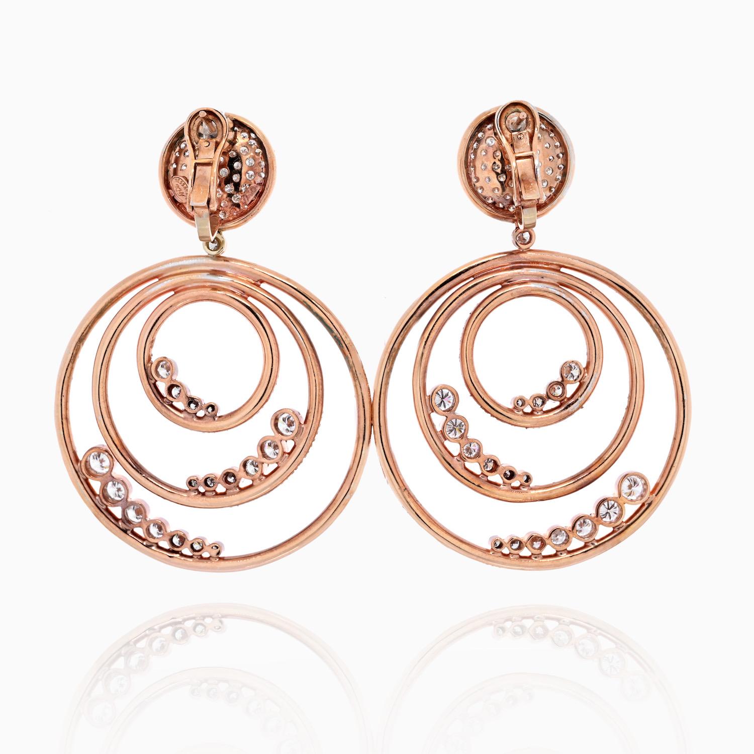 Spectacular diamond triple hoop earrings crafted in 18K rose gold. Mounted with 580 round cut diamonds and weight over 20 cttw in carat weight.  
Fastens with post and omega backing.
Total Length: 2.25 inches long. The Widest Circle: 52mm.
Fabolous