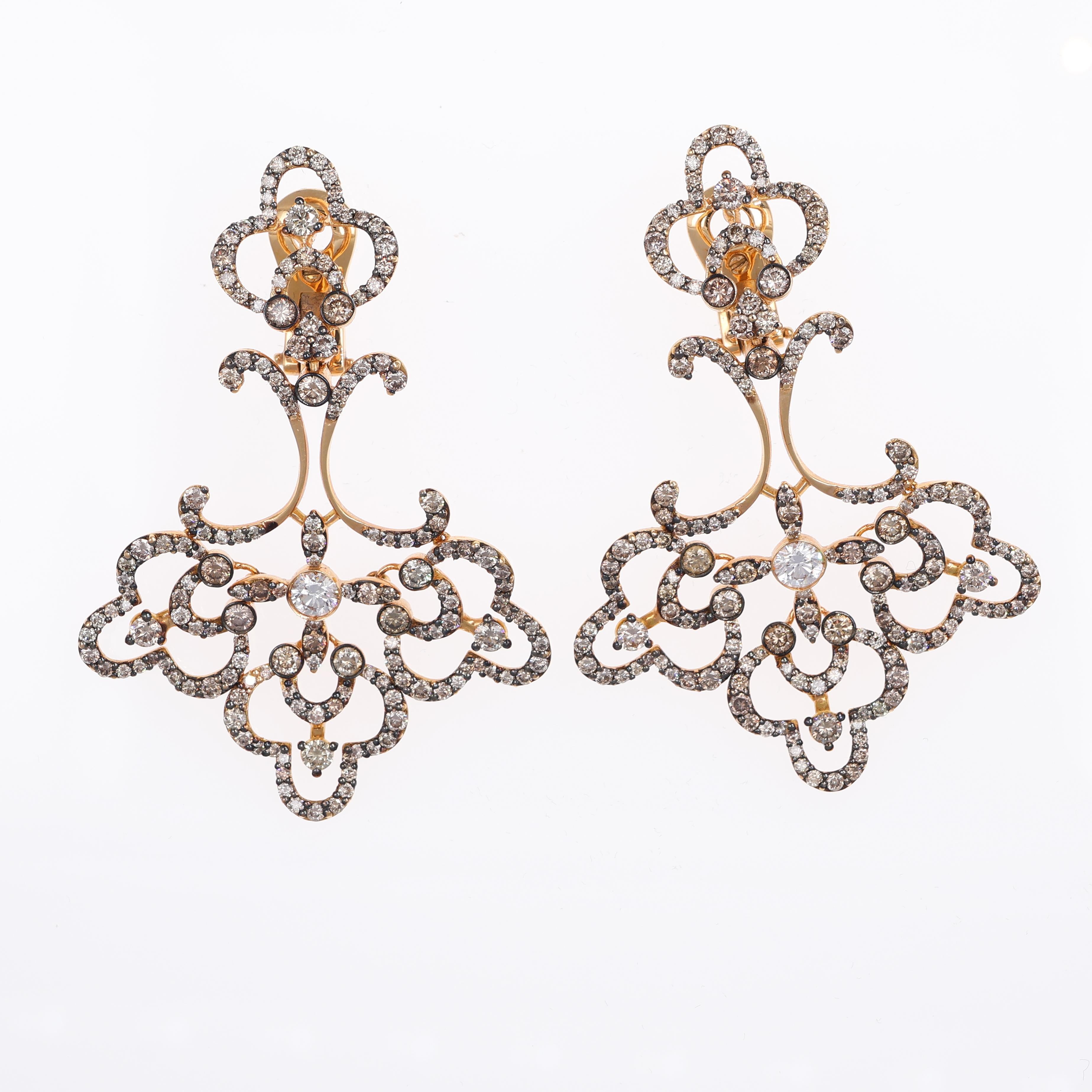 A magnificent pair of drop earrings crafted in 18K rose gold, showcasing an intricate filigree design adorned with natural brown diamonds totaling 5.17 carats and accented with white diamonds weighing 0.52 carats. These earrings combine