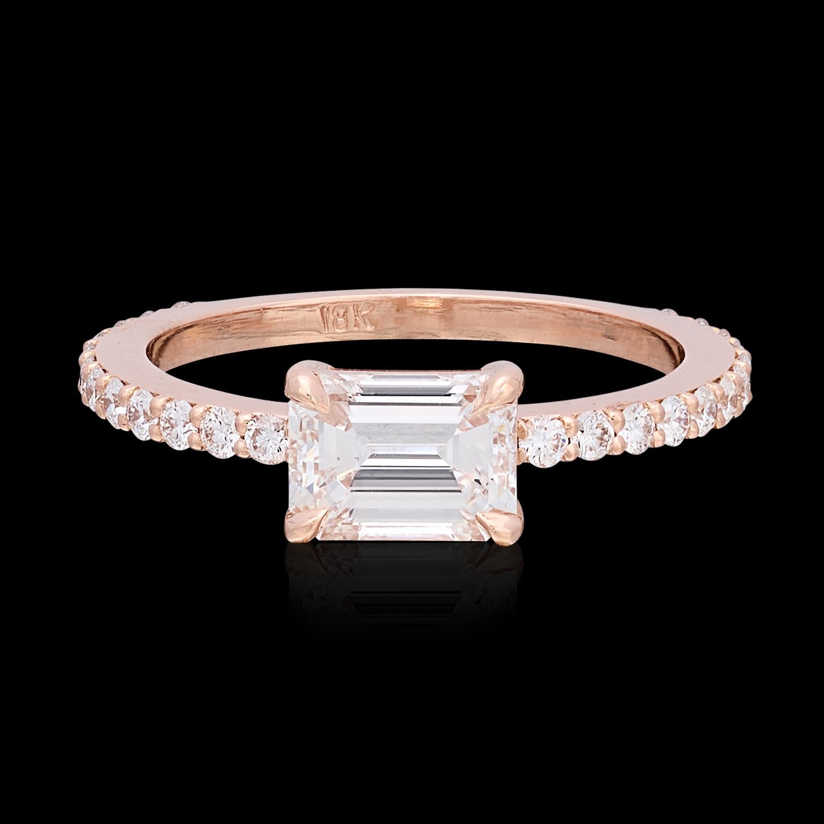 Stand out from the crowd with this truly unique twist on a classic design. This 18 karat rose gold stunner features a spectacular 1.04 carat emerald cut diamond set in an east/west horizontal fashion with an additional 18 diamonds going 3/4 around