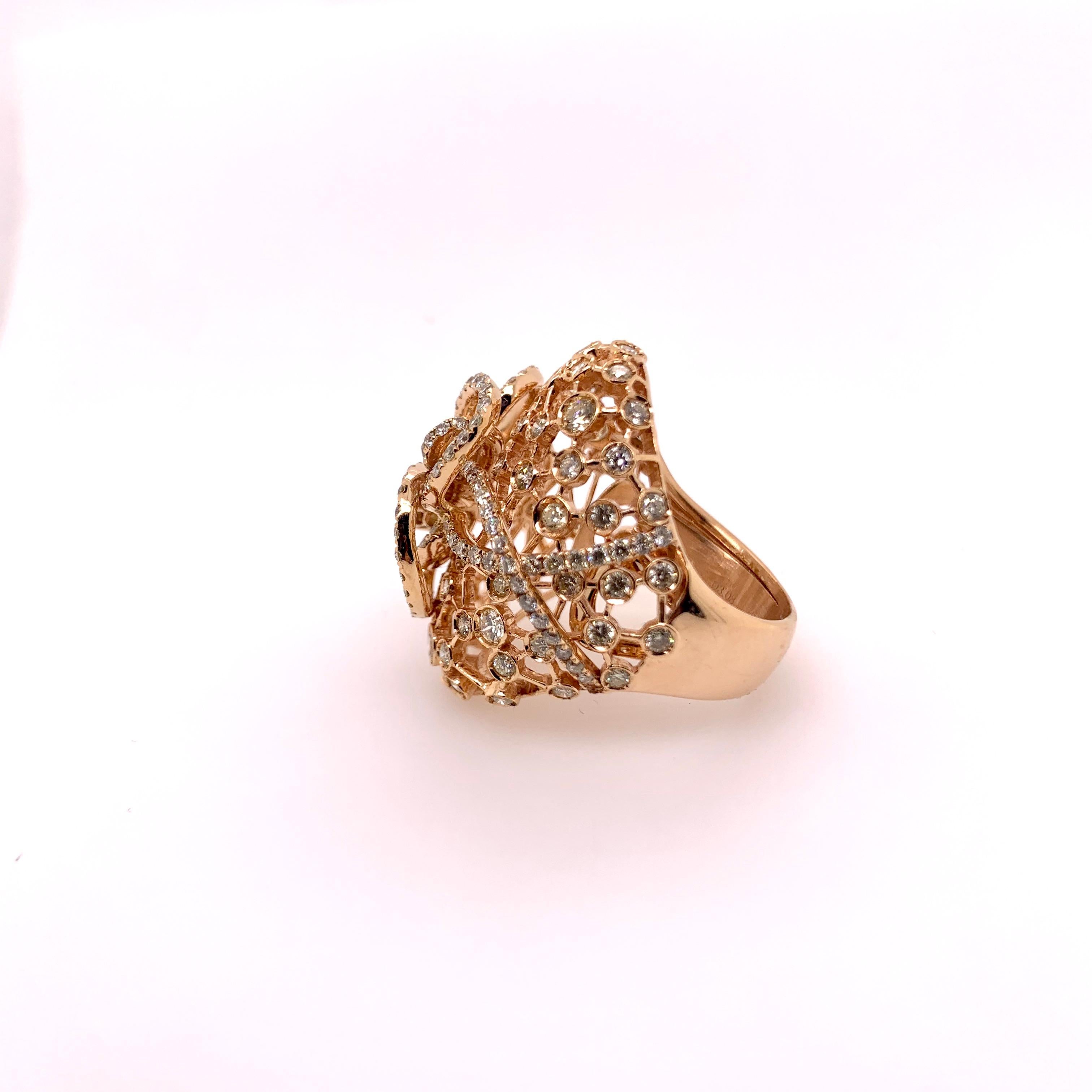 Elaborate diamond cocktail ring with all artistic curves and designs!   This stunning 18k rose gold diamond cocktail ring has so much detail to its design that its an art piece for your finger!   The round brilliant diamonds are bezel and prong set