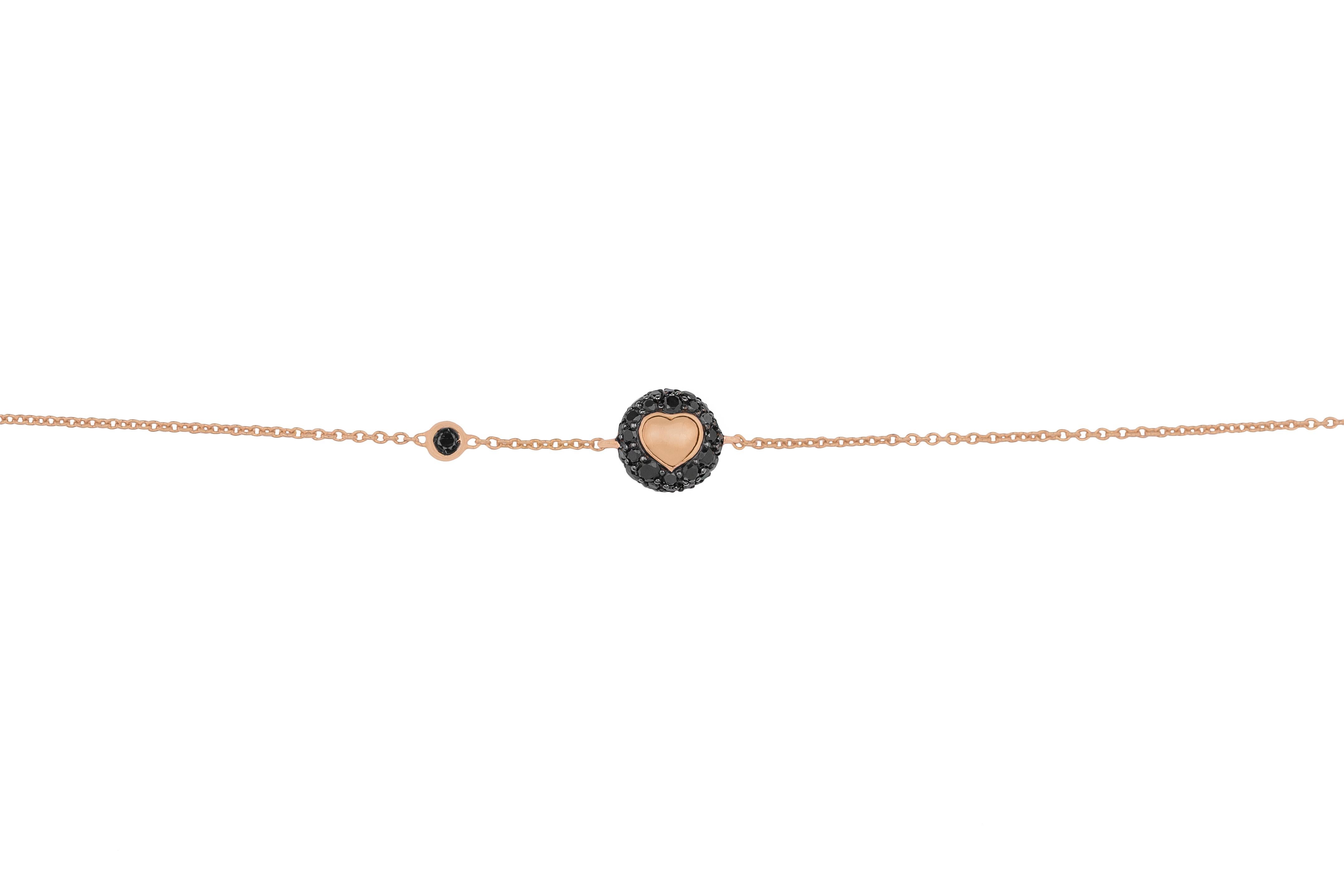 This 18K rose gold bracelet with black diamonds is made in Italy by Fanuele Gioielli.
It features a rose gold heart surrounded by brilliant-cut black diamonds, and a brilliant cut black diamond set in rose gold along the chain.
This bracelet has