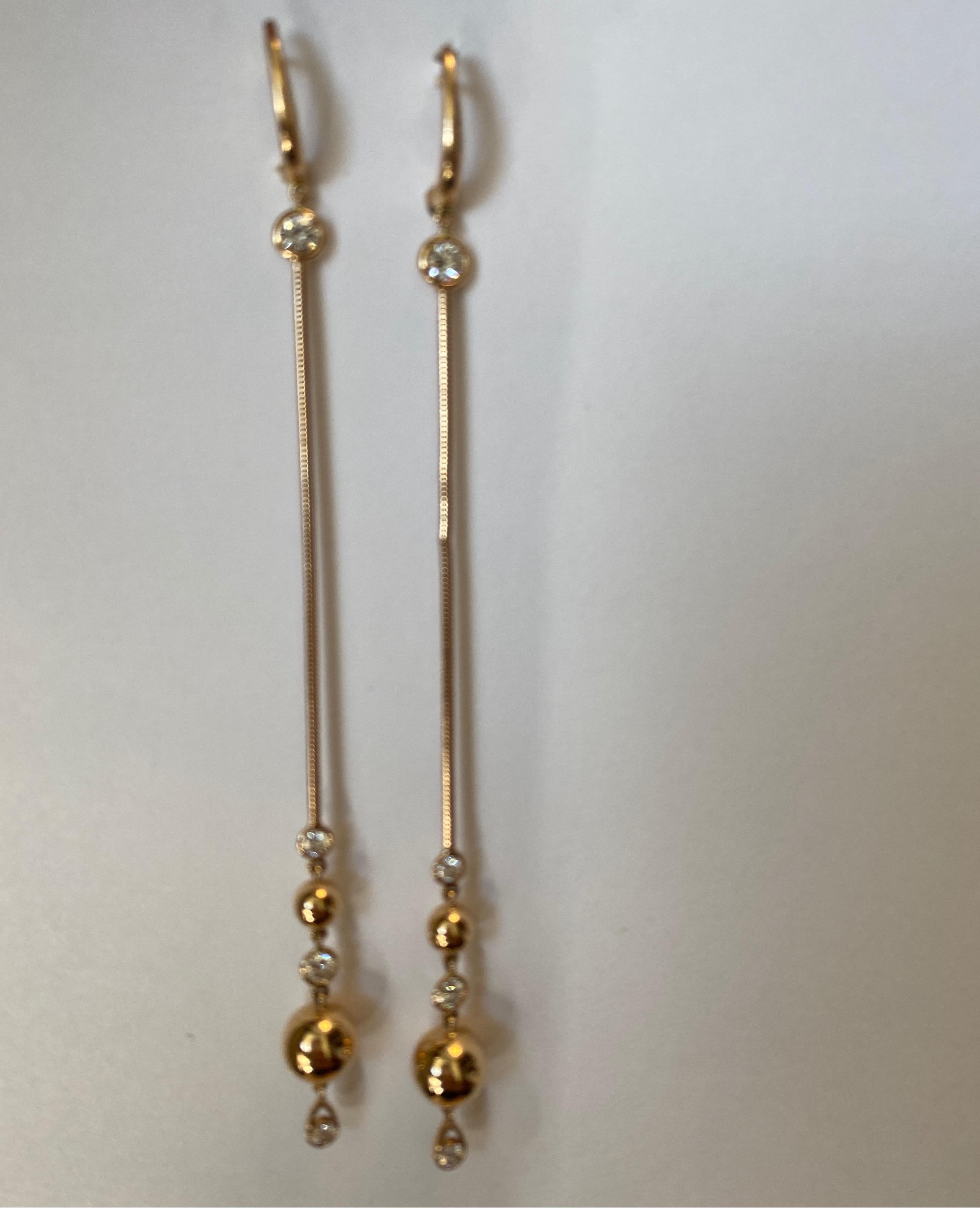18K rose gold long drop diamond earrings set with 8 full cut round diamonds weighing .82cts, by Crivelli.
Retail $4750