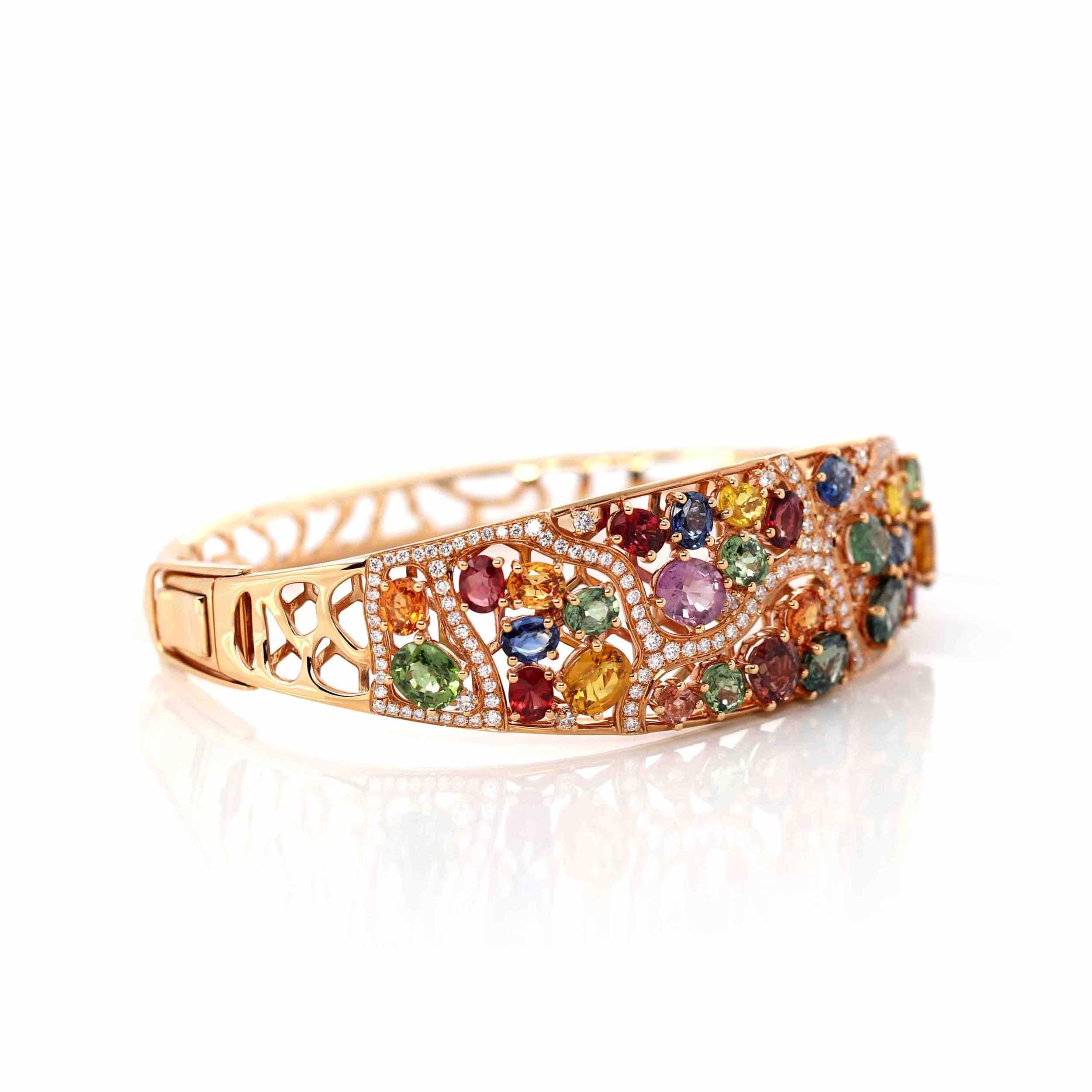 * DESIGN CONCEPT--- The design inspired by the dazzling colors of natural sapphires. The bangle is one of a kind, the stones are custom hand picked for this bracelet. Totaling 12.981ct of individual multi-colored sapphire. 4 prong setting. Alongside