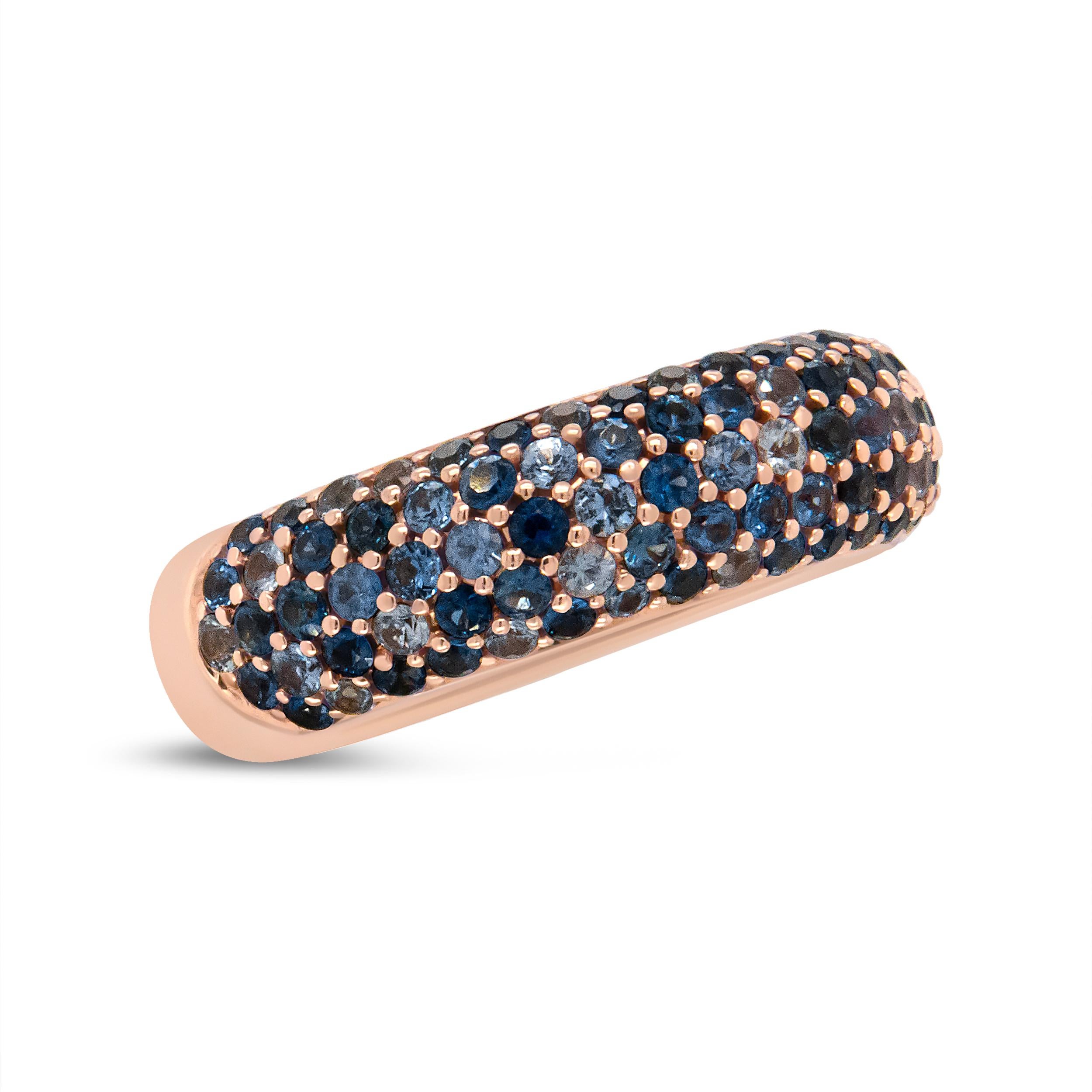 A glamorous piece reminiscent of the ocean, this rose gold band is embellished with stunning sapphires of different calibers of blue tones. The shaded blue gemstones are embellished on luxurious 18k rose gold for an overall striking and glamorous